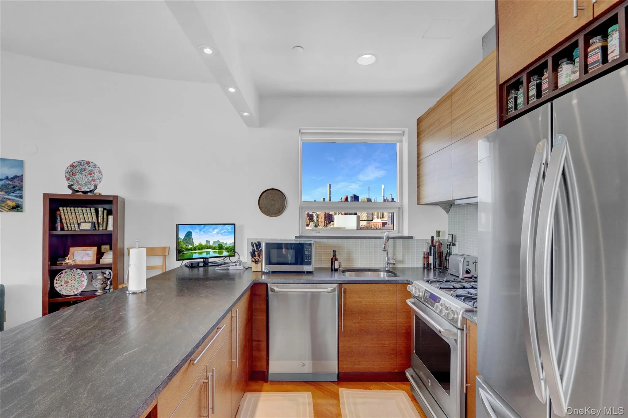 Kitchen with stainless steel appliances, a peninsula, tasteful backsplash, recessed lighting, and open shelves Kitchen with stainless steel appliances, a peninsula, tasteful backsplash, recessed lighting, and open shelves
