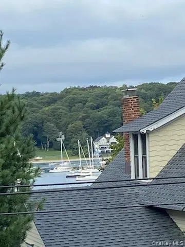 Exterior view of a shingled roof and a chimney Exterior view of a shingled roof and a chimney