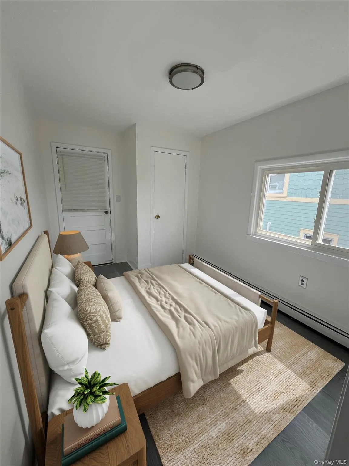 Bedroom featuring a baseboard radiator and wood finished floors Bedroom featuring a baseboard radiator and wood finished floors