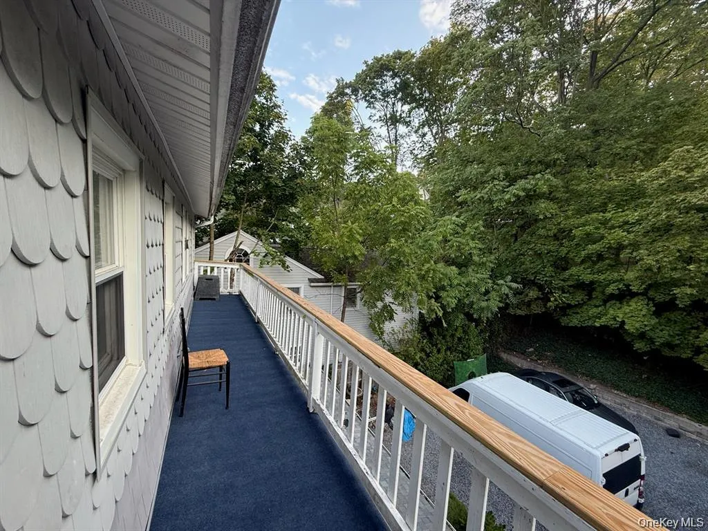 Balcony featuring view of wooded area Balcony featuring view of wooded area
