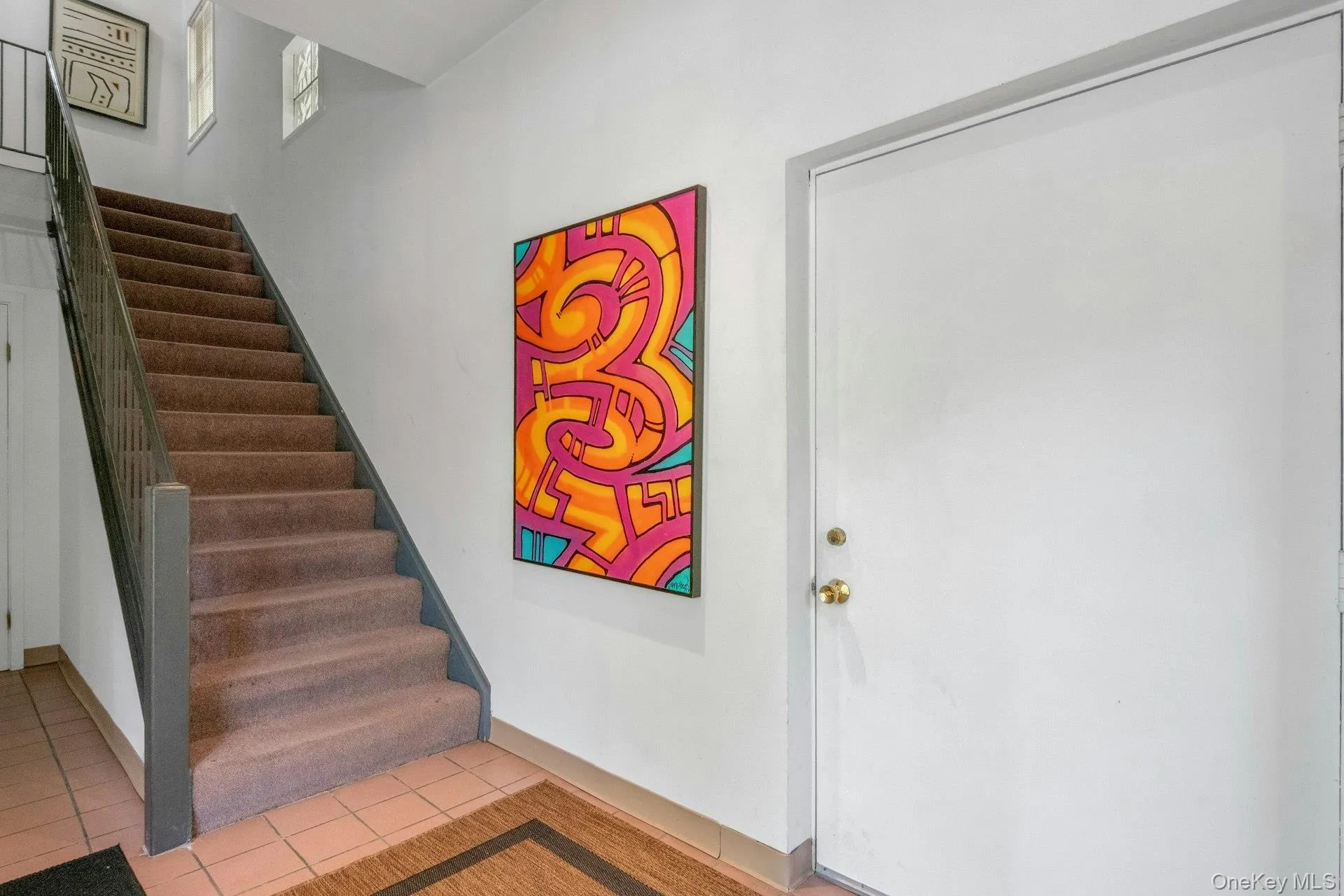 Stairway with tile patterned flooring and baseboards Stairway with tile patterned flooring and baseboards