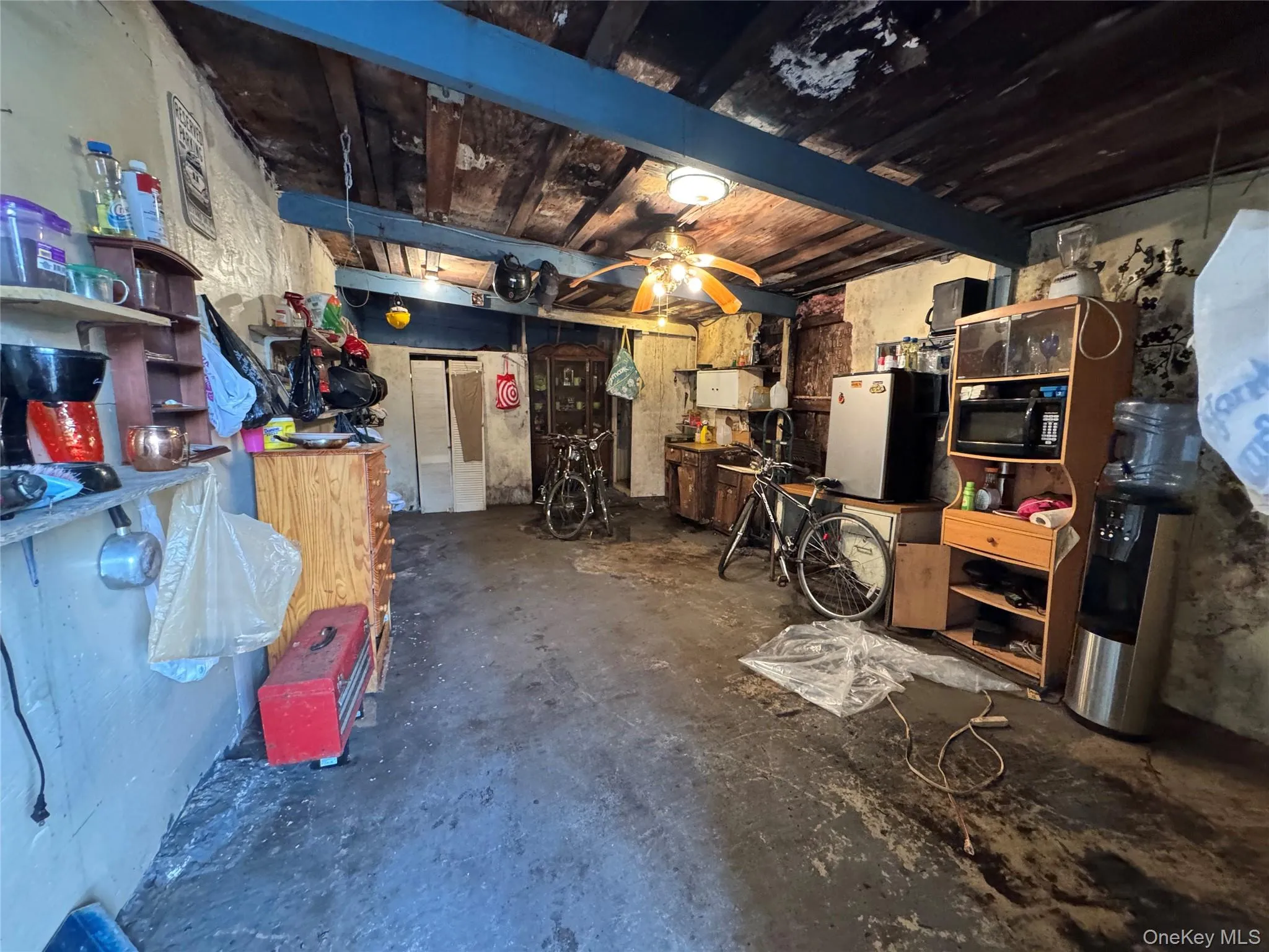 Basement with freestanding refrigerator and ceiling fan Basement with freestanding refrigerator and ceiling fan