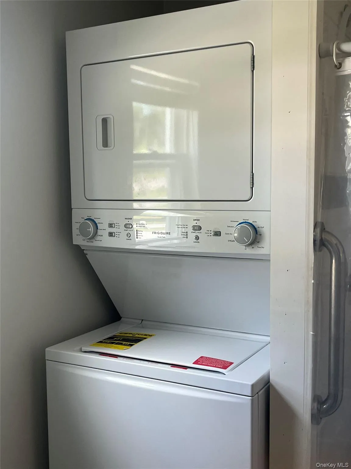 Laundry area with stacked washing machine and dryer Laundry area with stacked washing machine and dryer