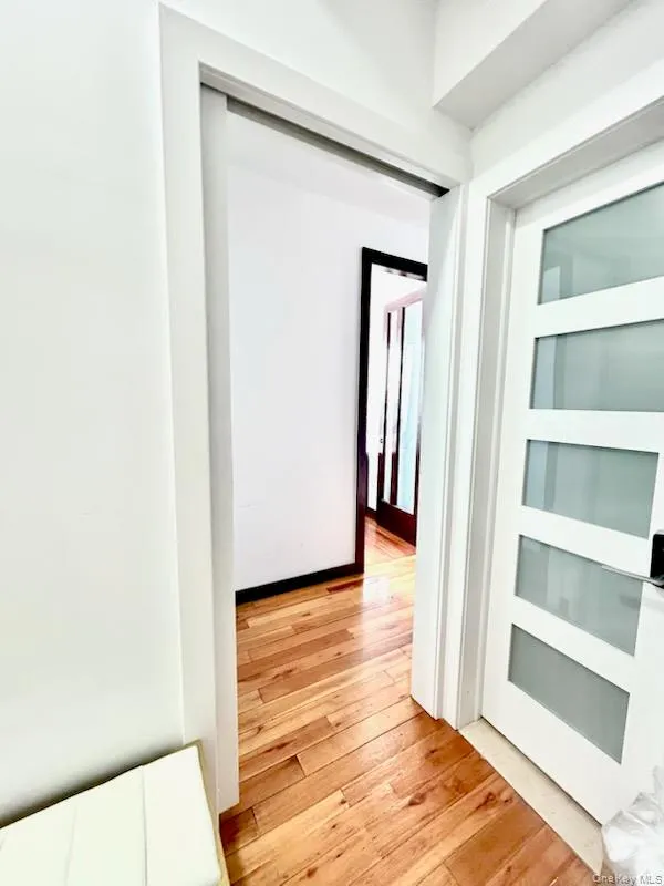 Hallway featuring light wood-style floors Hallway featuring light wood-style floors