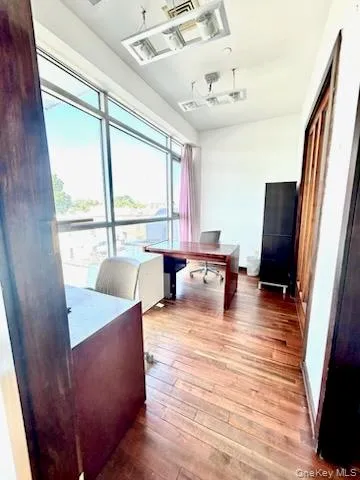 Home office with light wood-type flooring and baseboards Home office with light wood-type flooring and baseboards