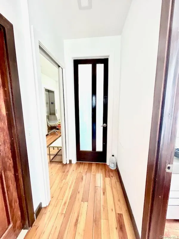 Foyer with light wood-style flooring and baseboards Foyer with light wood-style flooring and baseboards