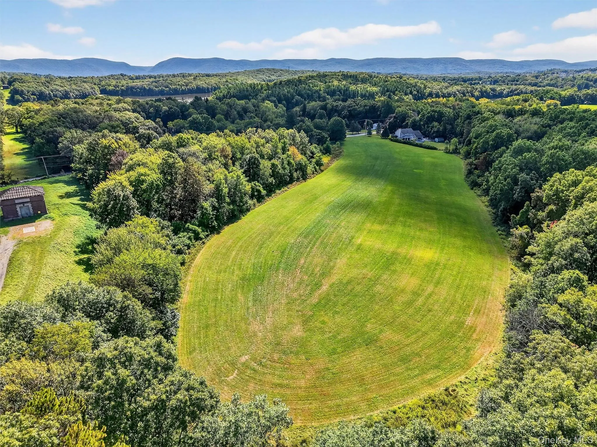 Aerial view of a heavily wooded area and mountains Aerial view of a heavily wooded area and mountains