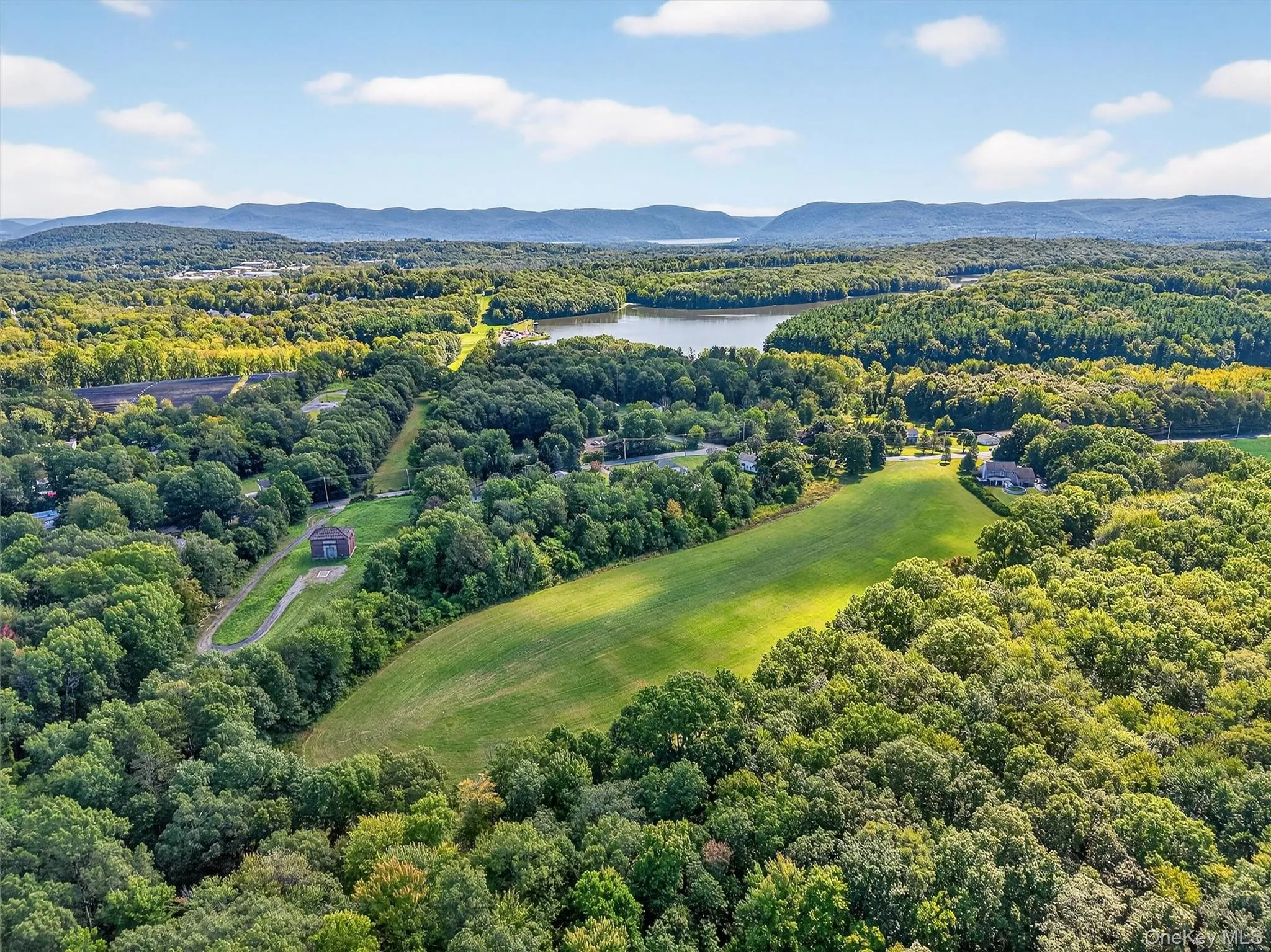 Drone / aerial view of a forest and a water and mountain view Drone / aerial view of a forest and a water and mountain view