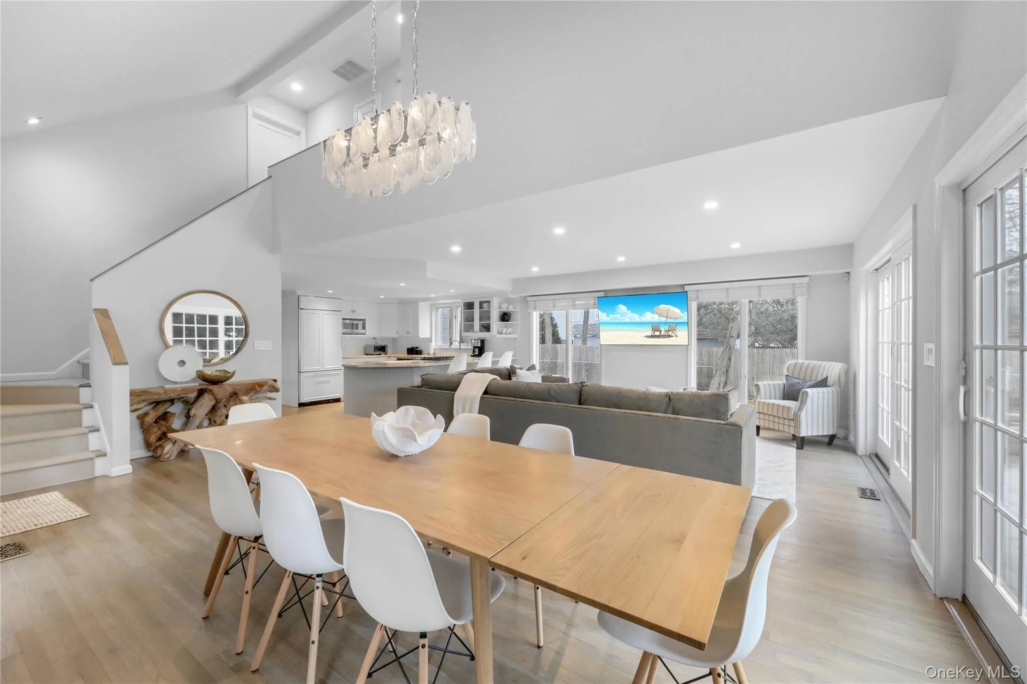Dining area with stairway, light wood-type flooring, recessed lighting, and a towering ceiling Dining area with stairway, light wood-type flooring, recessed lighting, and a towering ceiling