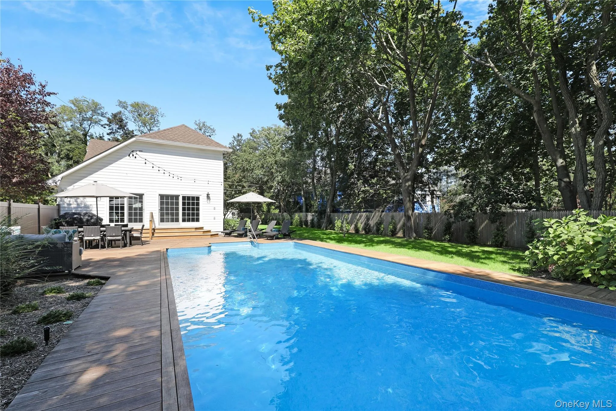 View of pool featuring a fenced backyard, a patio area, and outdoor dining area View of pool featuring a fenced backyard, a patio area, and outdoor dining area