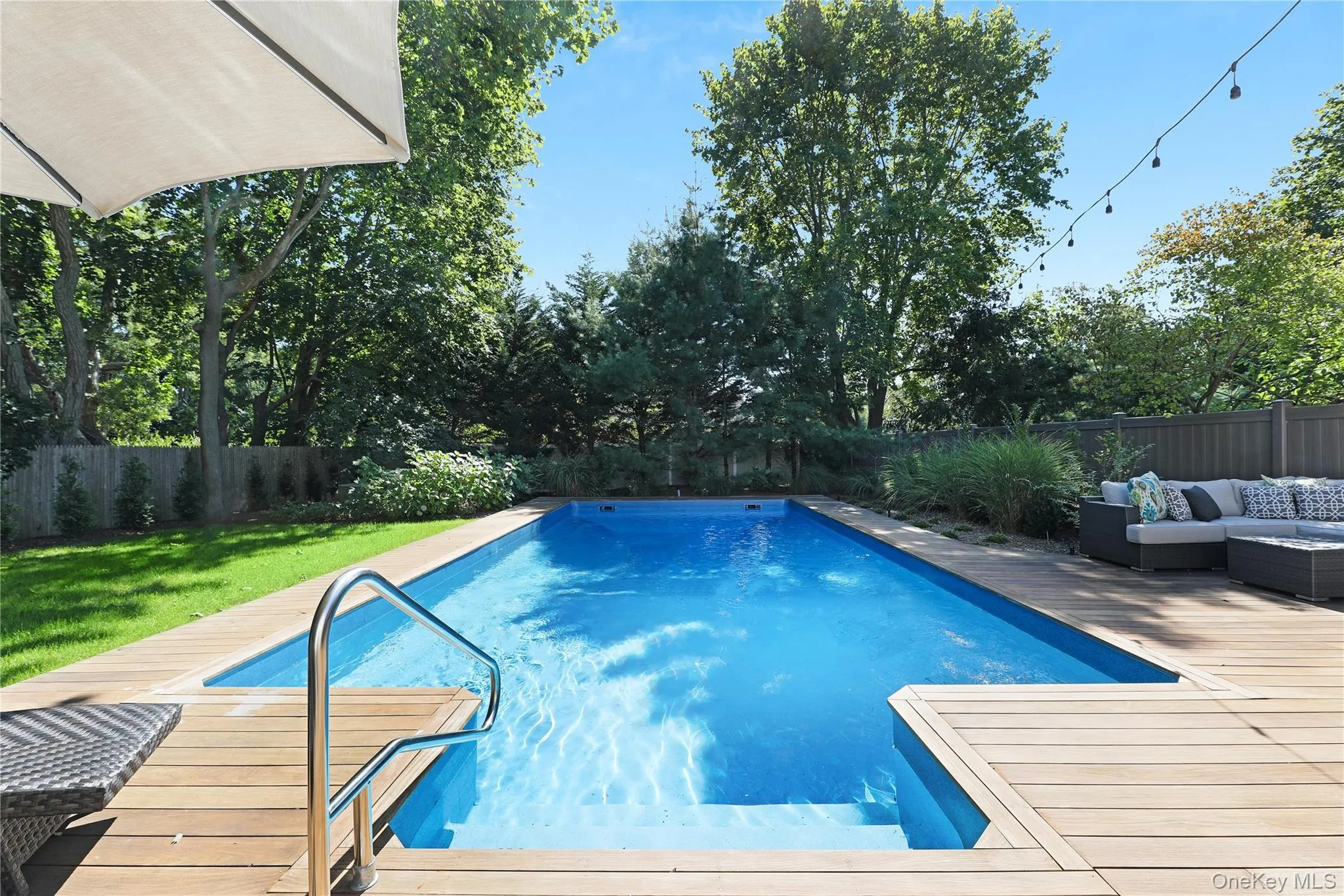 View of pool with a fenced backyard, an outdoor hangout area, and a patio area View of pool with a fenced backyard, an outdoor hangout area, and a patio area
