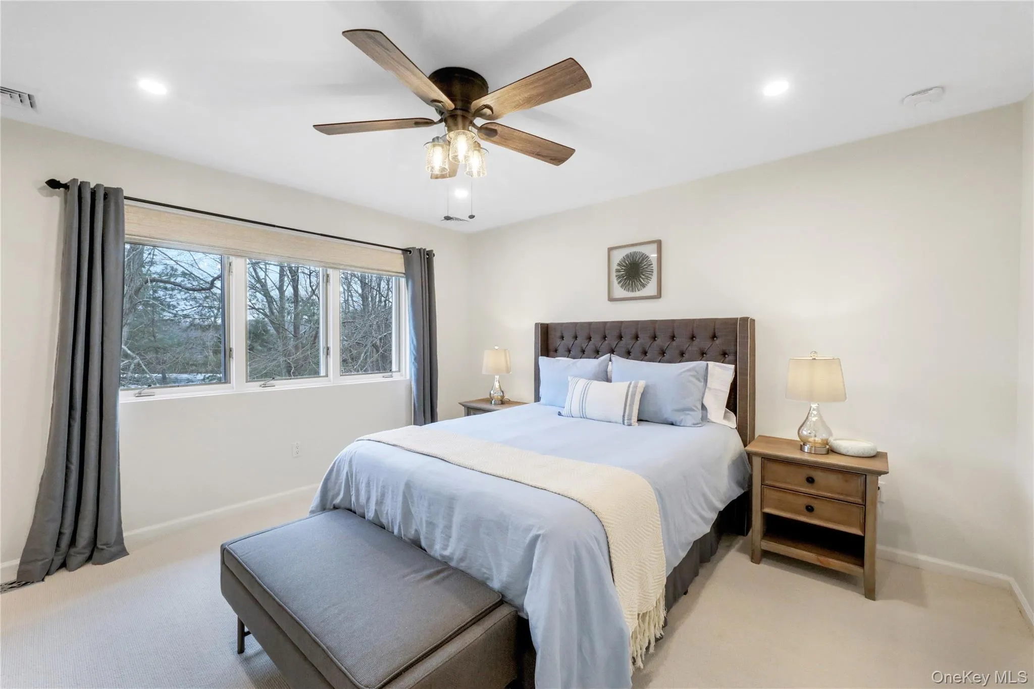 Bedroom featuring light colored carpet, recessed lighting, and a ceiling fan Bedroom featuring light colored carpet, recessed lighting, and a ceiling fan