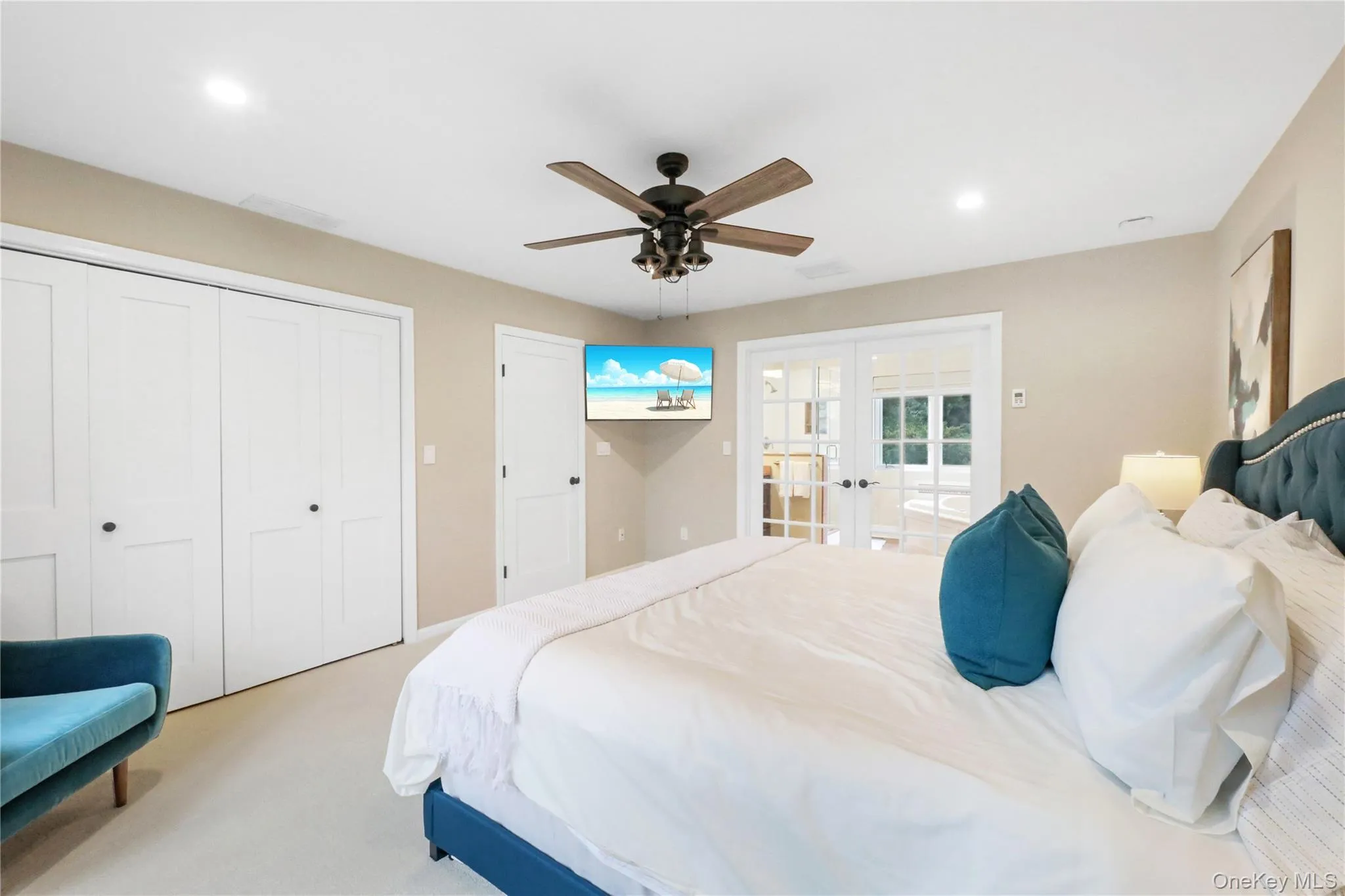 Bedroom with french doors, carpet flooring, a closet, ceiling fan, and recessed lighting Bedroom with french doors, carpet flooring, a closet, ceiling fan, and recessed lighting