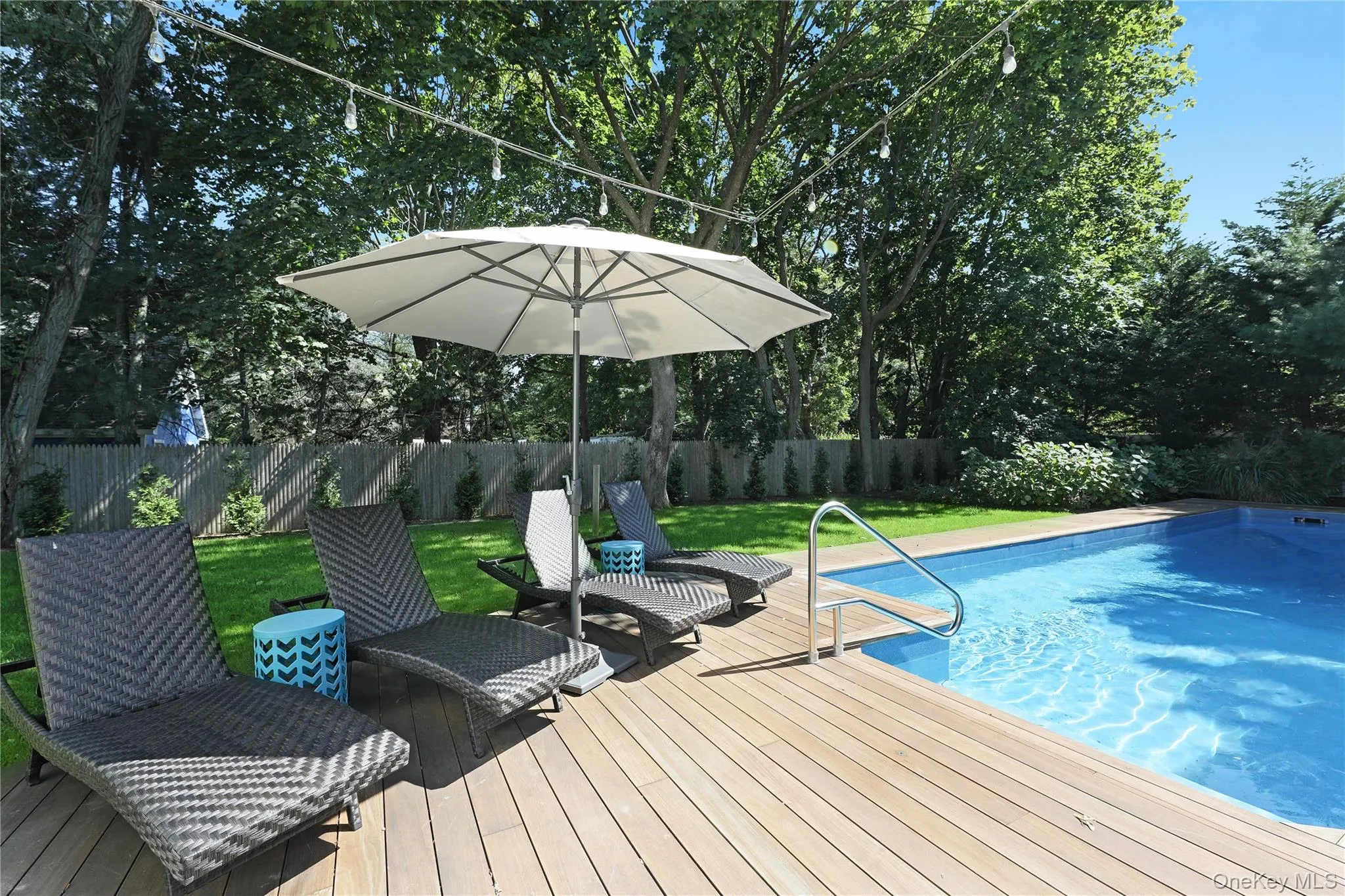 View of swimming pool with a fenced backyard and a deck View of swimming pool with a fenced backyard and a deck