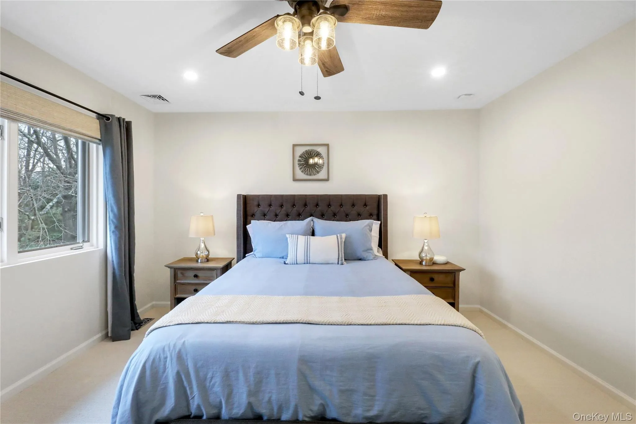 Bedroom featuring light colored carpet, recessed lighting, and ceiling fan Bedroom featuring light colored carpet, recessed lighting, and ceiling fan
