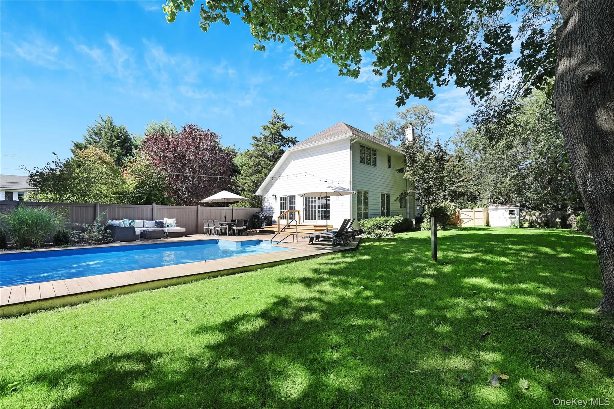 View of swimming pool featuring outdoor lounge area, a fenced backyard, an outdoor structure, and a patio View of swimming pool featuring outdoor lounge area, a fenced backyard, an outdoor structure, and a patio
