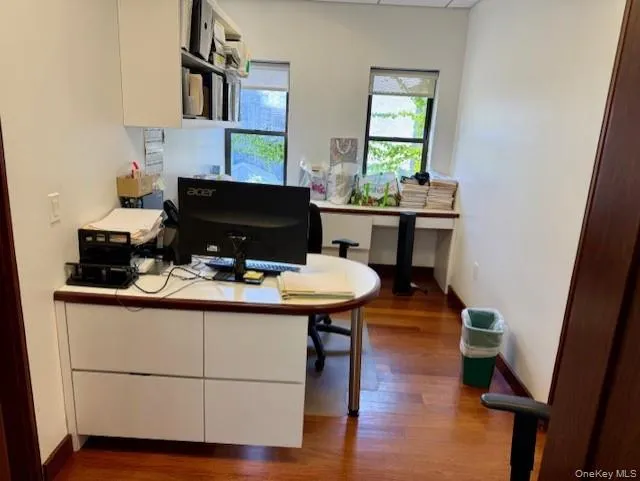 Office featuring dark wood-type flooring and baseboards Office featuring dark wood-type flooring and baseboards