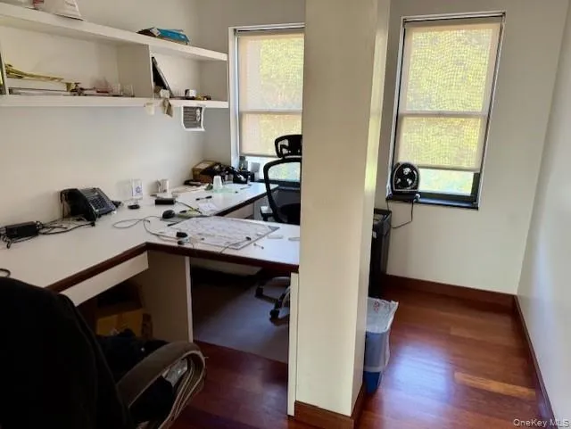 Office space with dark wood-type flooring Office space with dark wood-type flooring