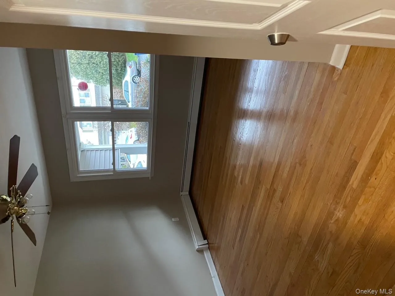 Unfurnished room with light wood-type flooring, baseboard heating, and ceiling fan Unfurnished room with light wood-type flooring, baseboard heating, and ceiling fan