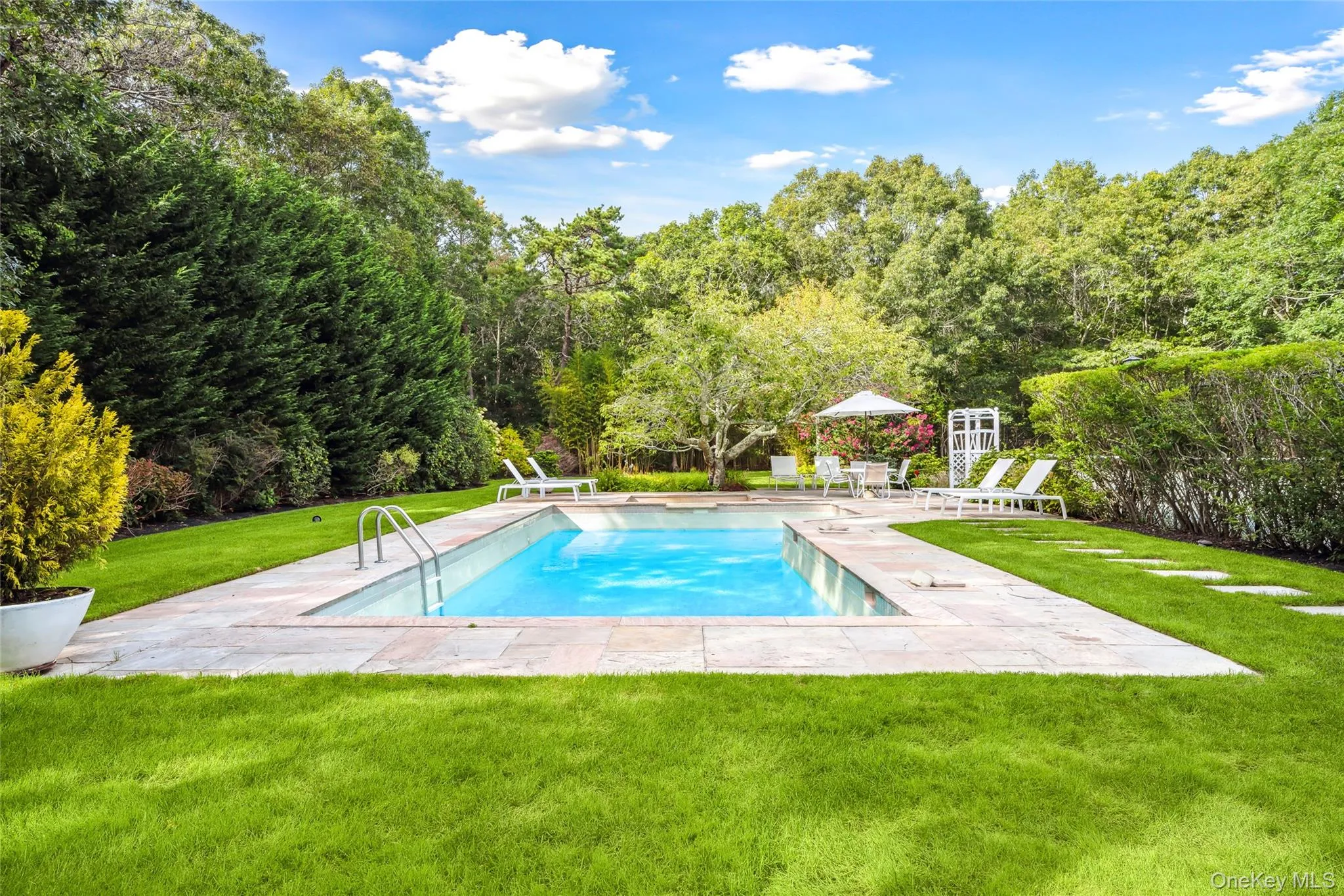 Swimming pool with a patio area, a yard, and a gazebo Swimming pool with a patio area, a yard, and a gazebo