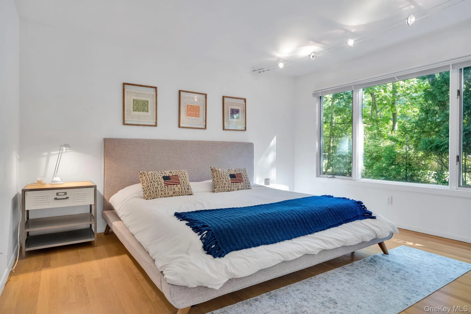 Bedroom featuring light wood-type flooring and baseboards Bedroom featuring light wood-type flooring and baseboards