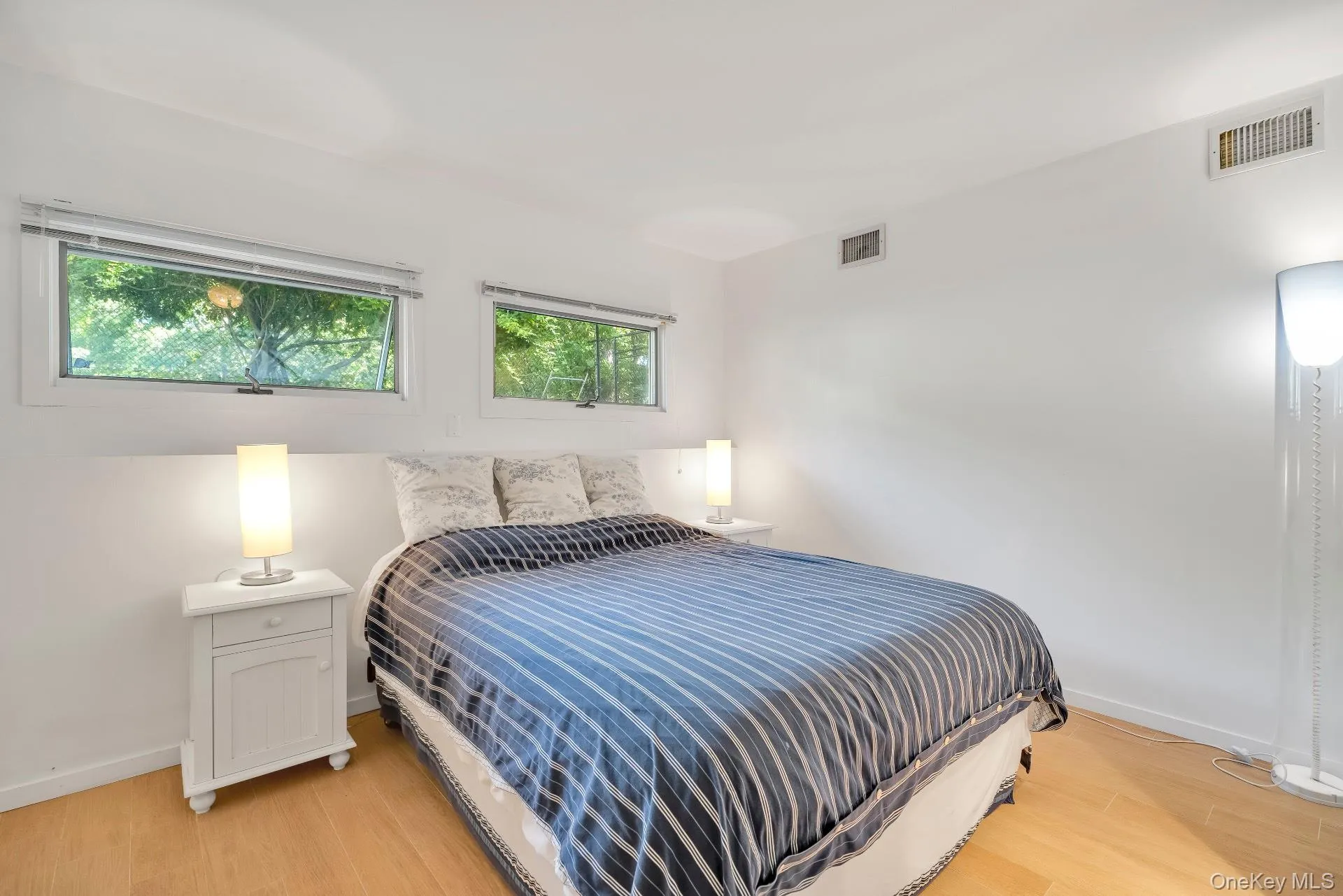Bedroom featuring light wood-type flooring and baseboards Bedroom featuring light wood-type flooring and baseboards