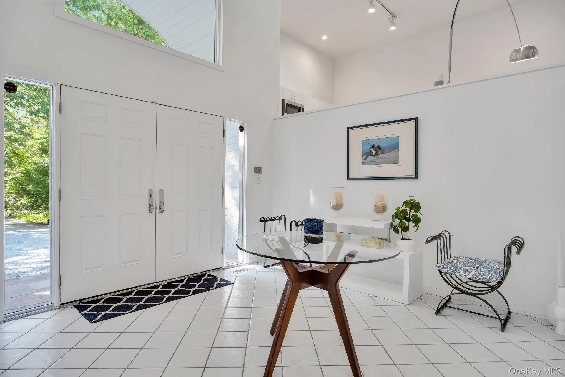 Foyer featuring a towering ceiling and light tile patterned floors Foyer featuring a towering ceiling and light tile patterned floors