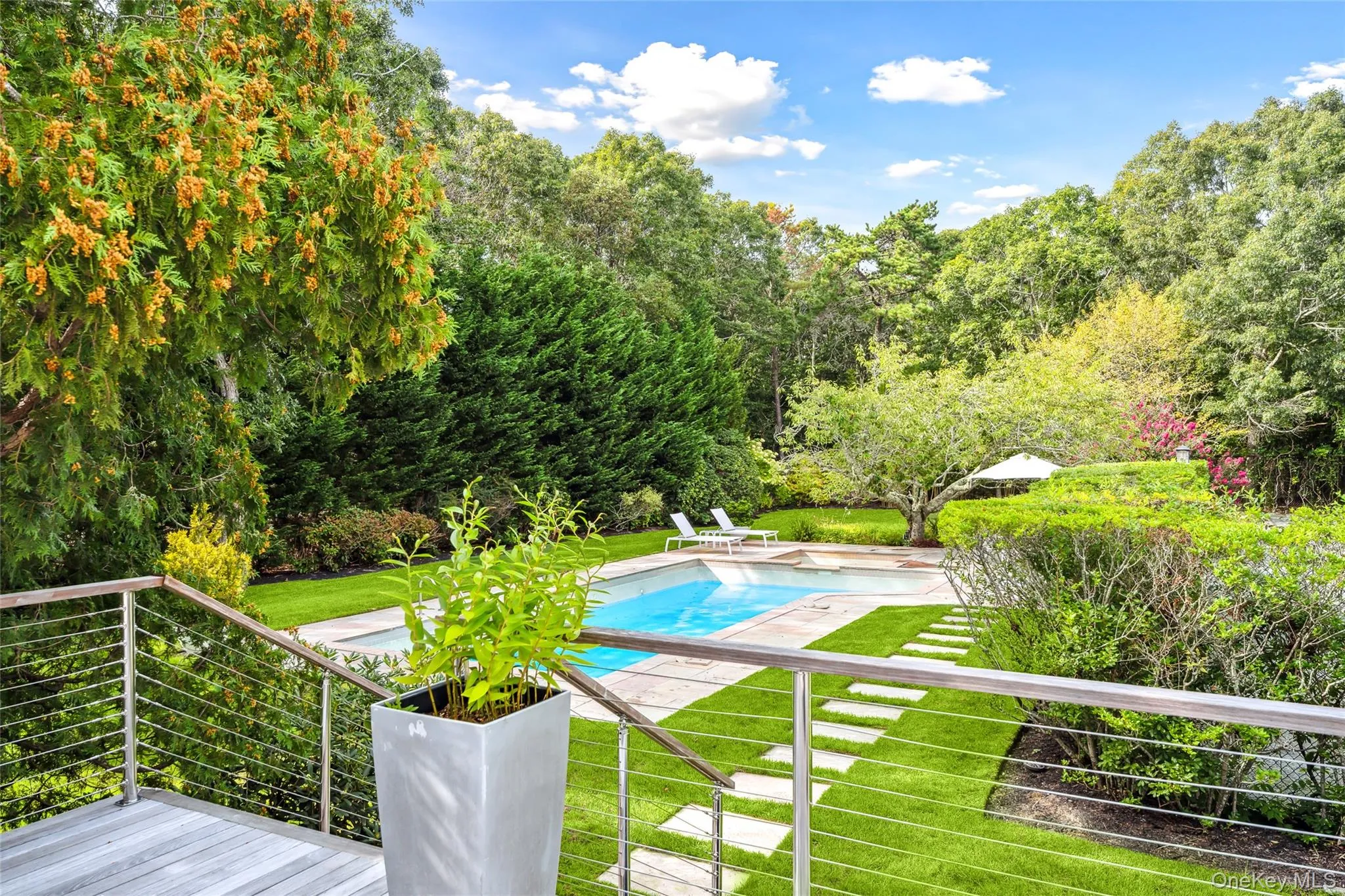 Swimming pool featuring a yard and a patio area Swimming pool featuring a yard and a patio area