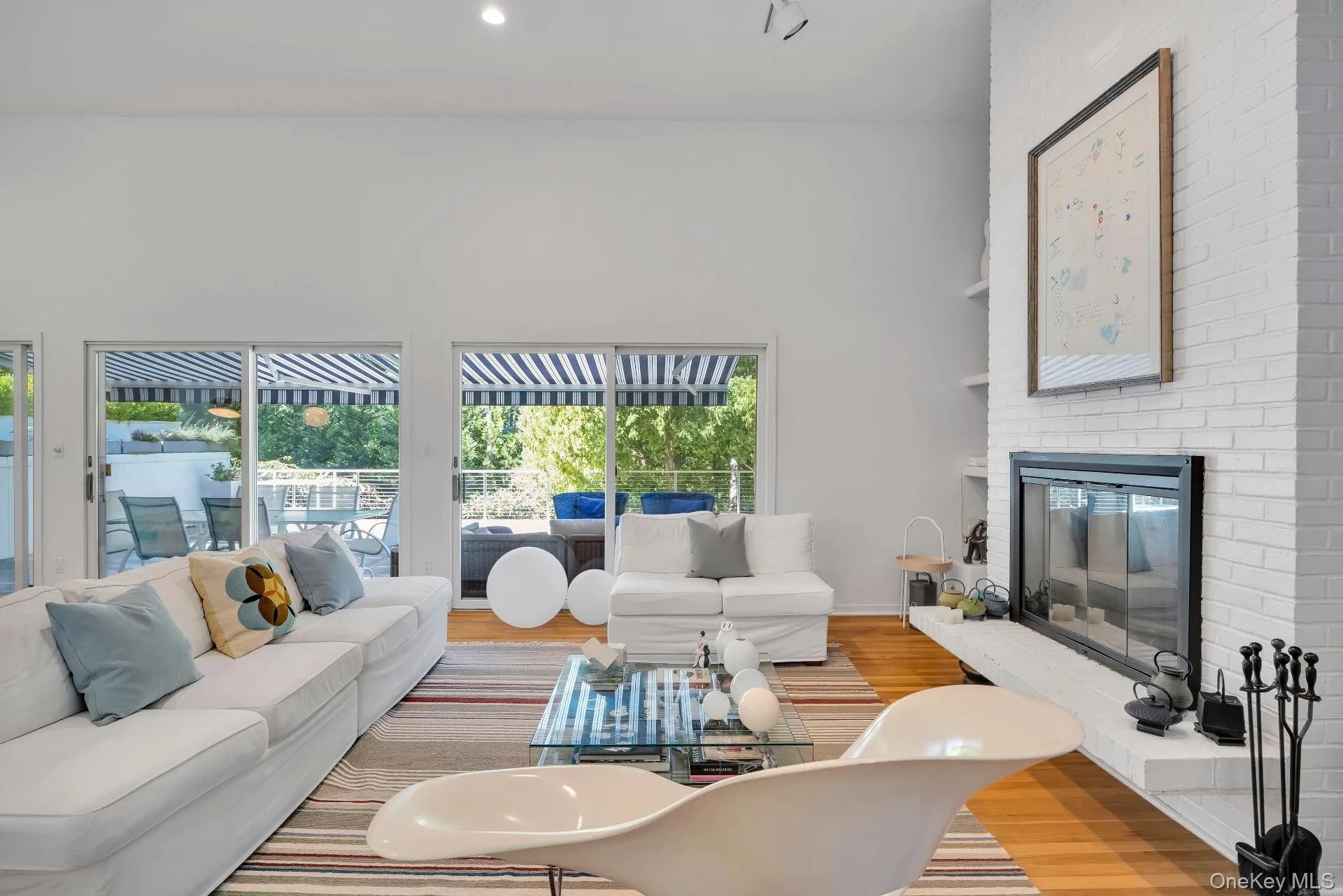 Living area featuring wood finished floors, a fireplace, recessed lighting, and built in shelves Living area featuring wood finished floors, a fireplace, recessed lighting, and built in shelves