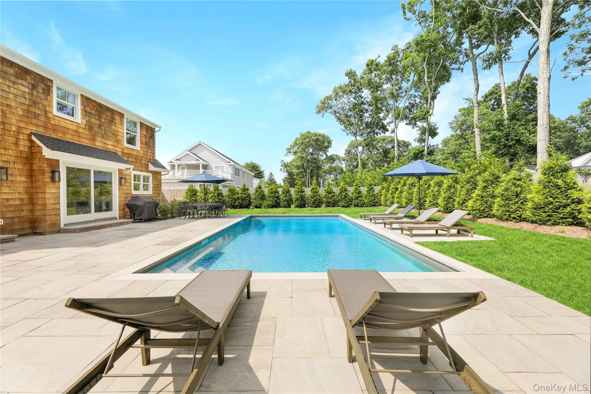 View of swimming pool with a patio, grilling area, and a yard View of swimming pool with a patio, grilling area, and a yard