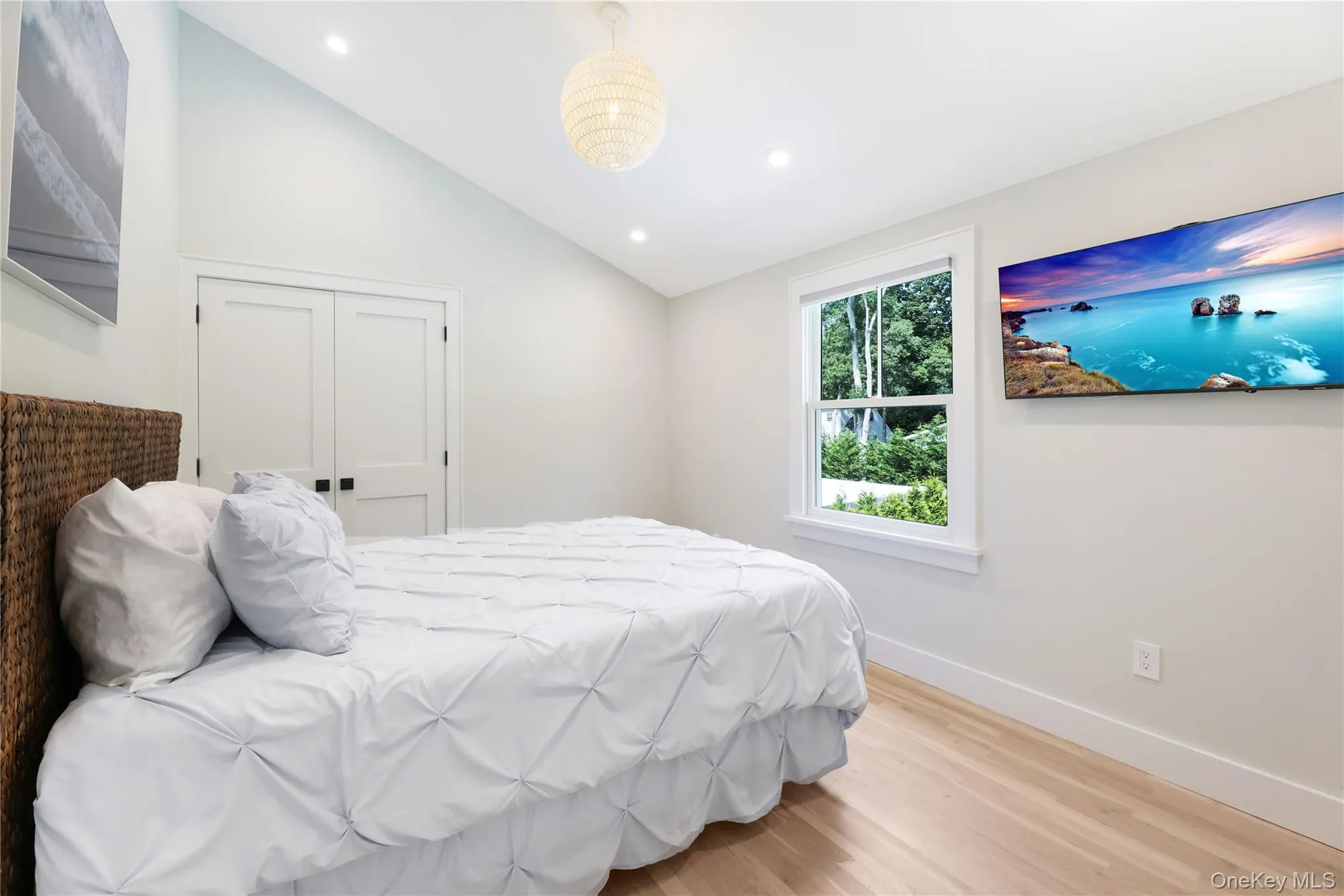Bedroom with light wood-type flooring, lofted ceiling, recessed lighting, and a closet Bedroom with light wood-type flooring, lofted ceiling, recessed lighting, and a closet
