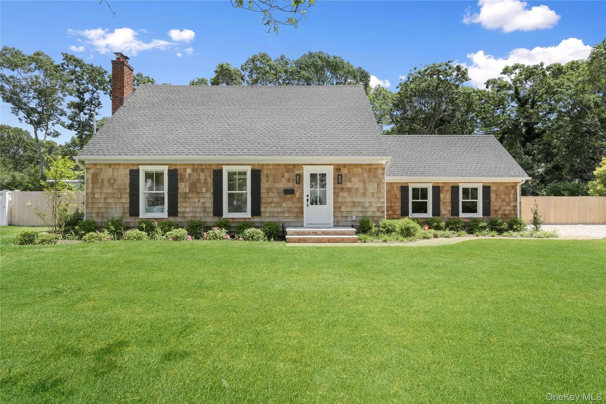 View of front of home with a chimney and a shingled roof View of front of home with a chimney and a shingled roof