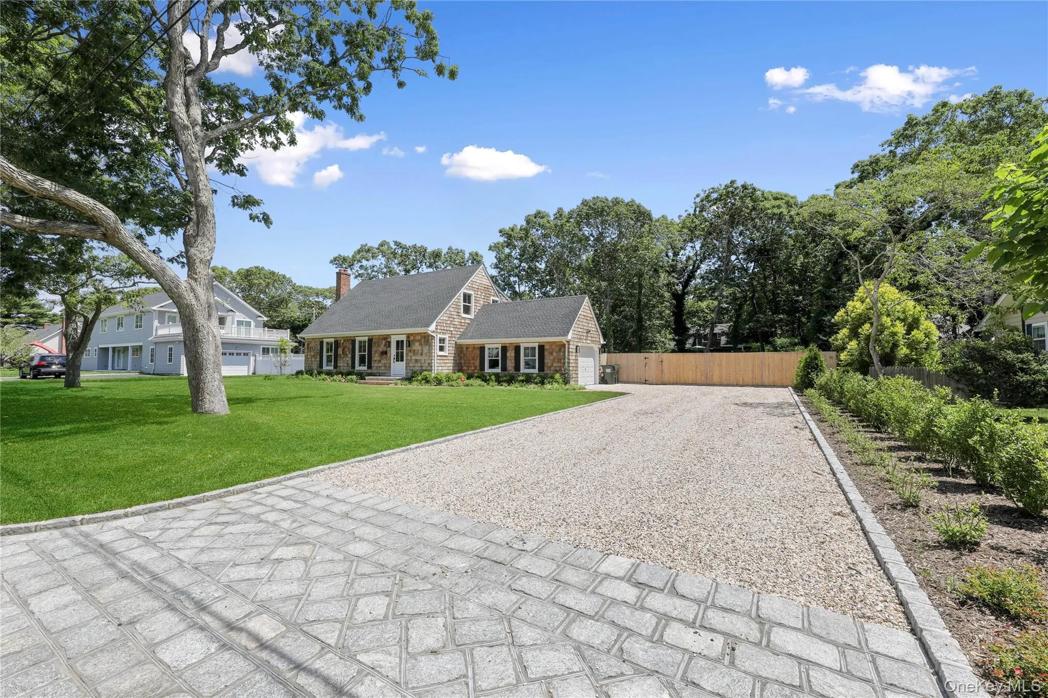 Cape cod house with driveway and a chimney Cape cod house with driveway and a chimney