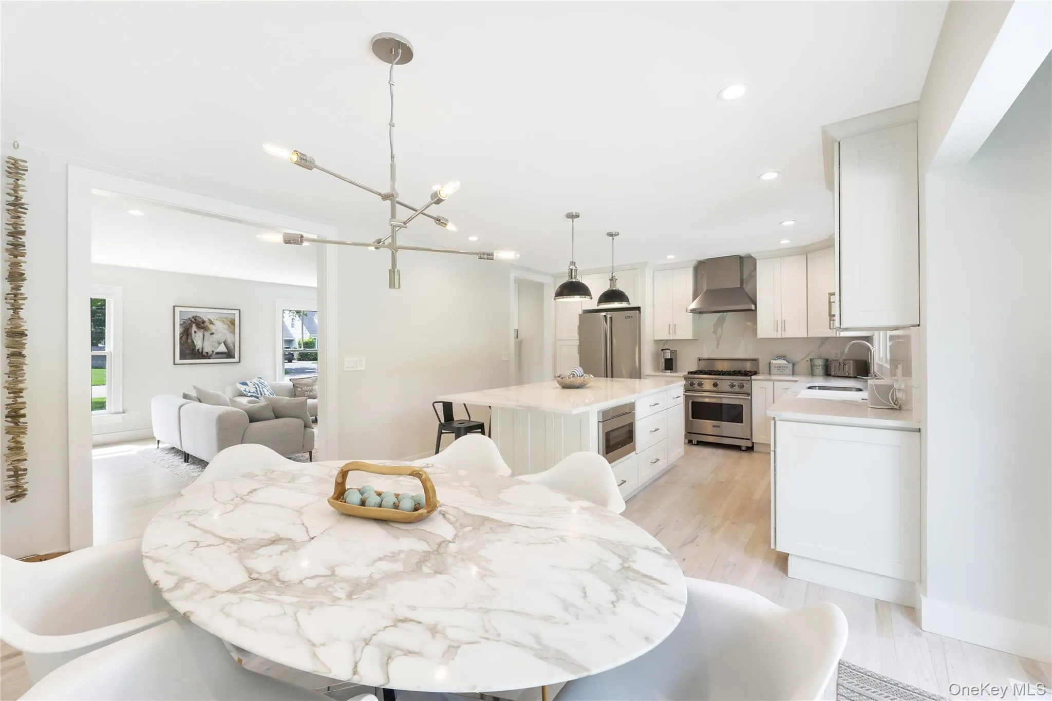 Dining room featuring light wood-type flooring, a chandelier, and recessed lighting Dining room featuring light wood-type flooring, a chandelier, and recessed lighting