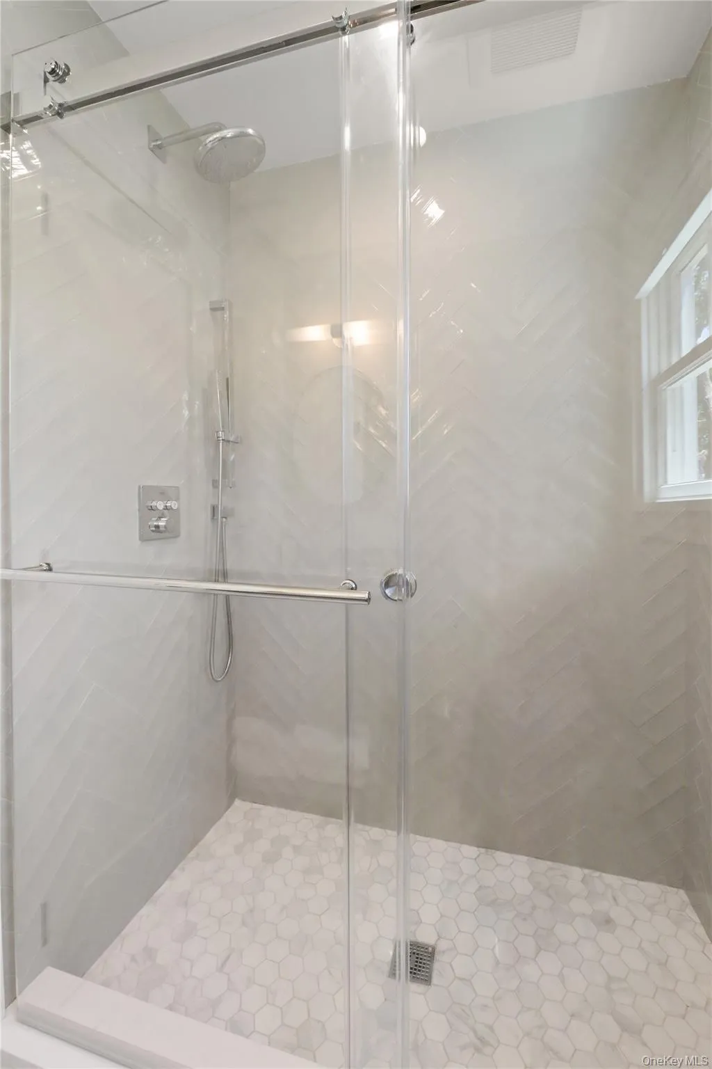 Bathroom featuring a shower stall Bathroom featuring a shower stall