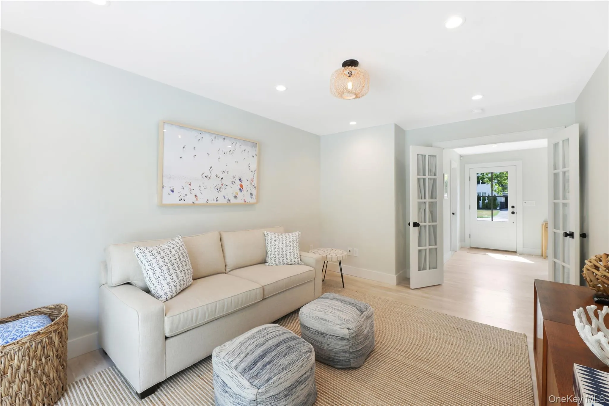 Living room with french doors, recessed lighting, and wood finished floors Living room with french doors, recessed lighting, and wood finished floors
