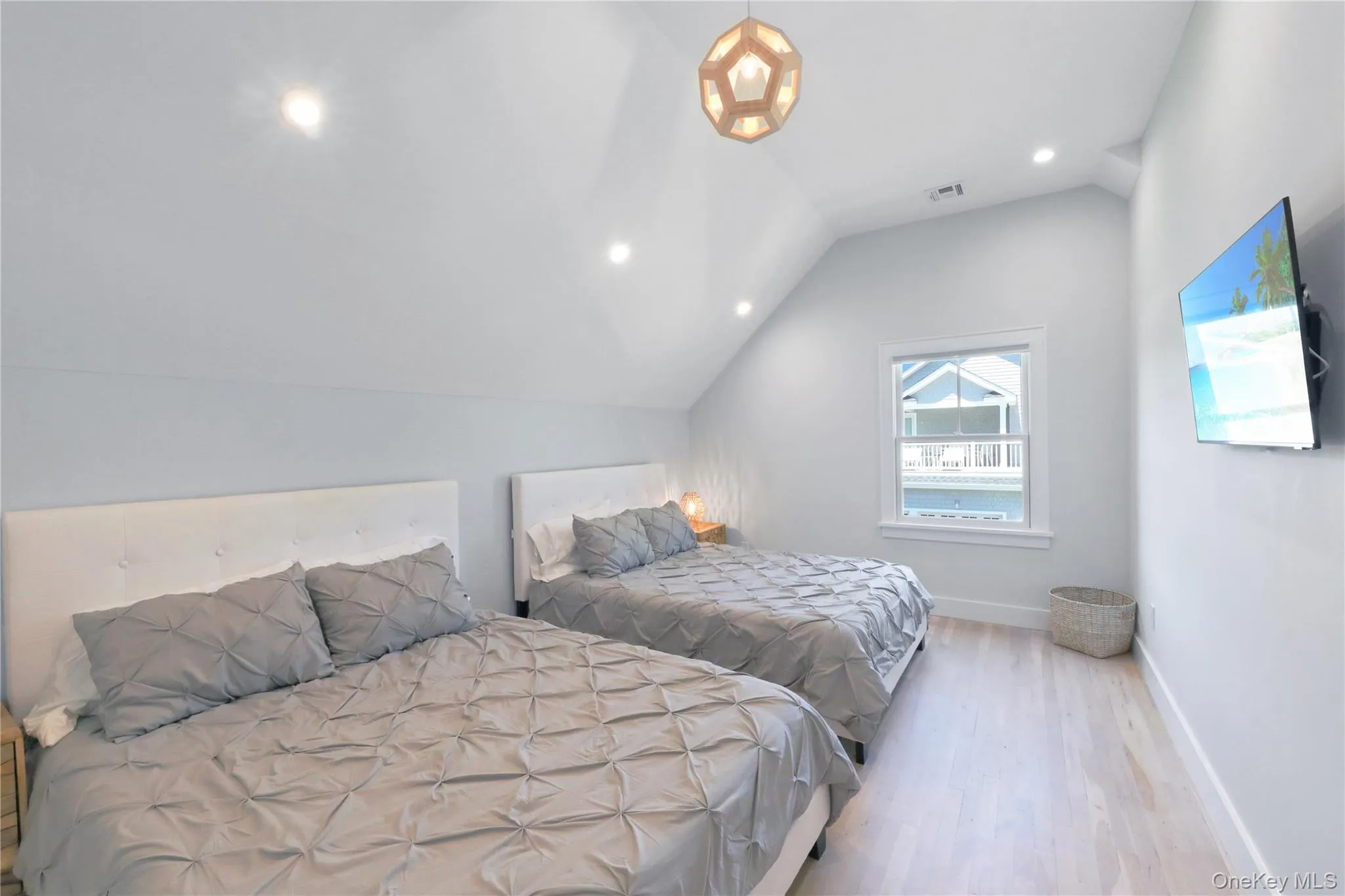 Bedroom featuring vaulted ceiling, wood finished floors, and recessed lighting Bedroom featuring vaulted ceiling, wood finished floors, and recessed lighting