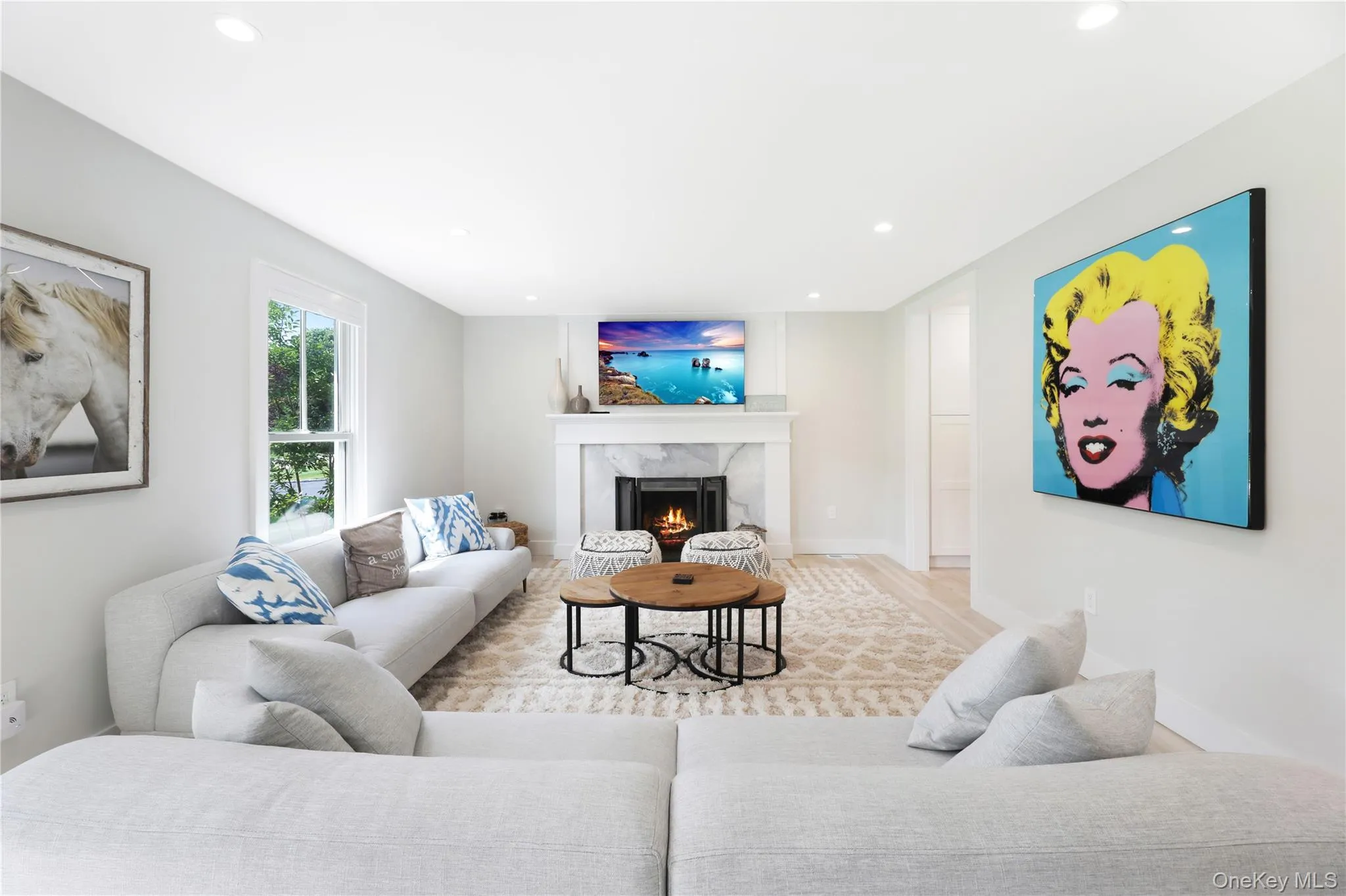 Living room with a fireplace, recessed lighting, and wood finished floors Living room with a fireplace, recessed lighting, and wood finished floors