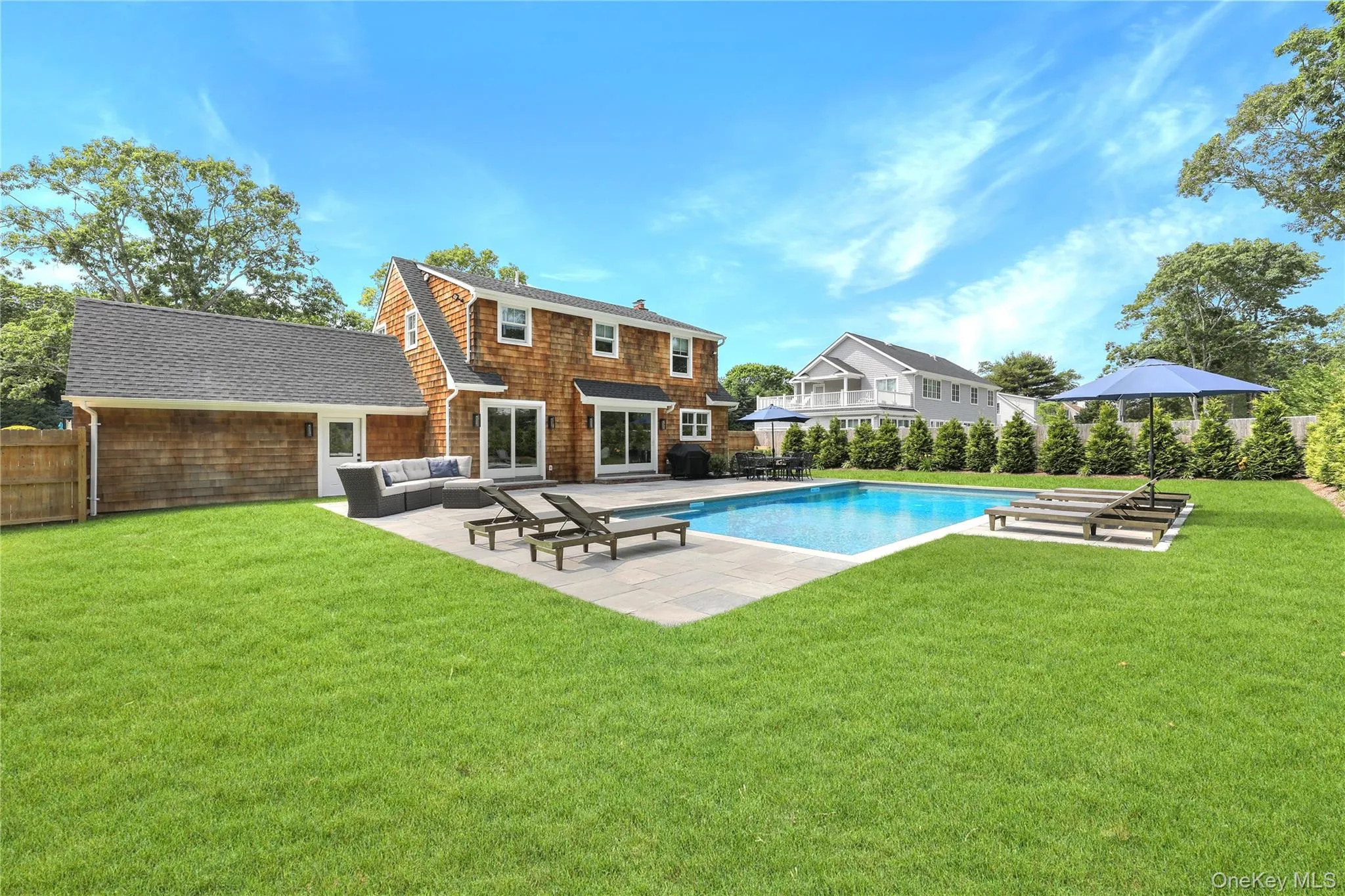 View of pool featuring a patio, a lawn, an outdoor living space, and area for grilling View of pool featuring a patio, a lawn, an outdoor living space, and area for grilling