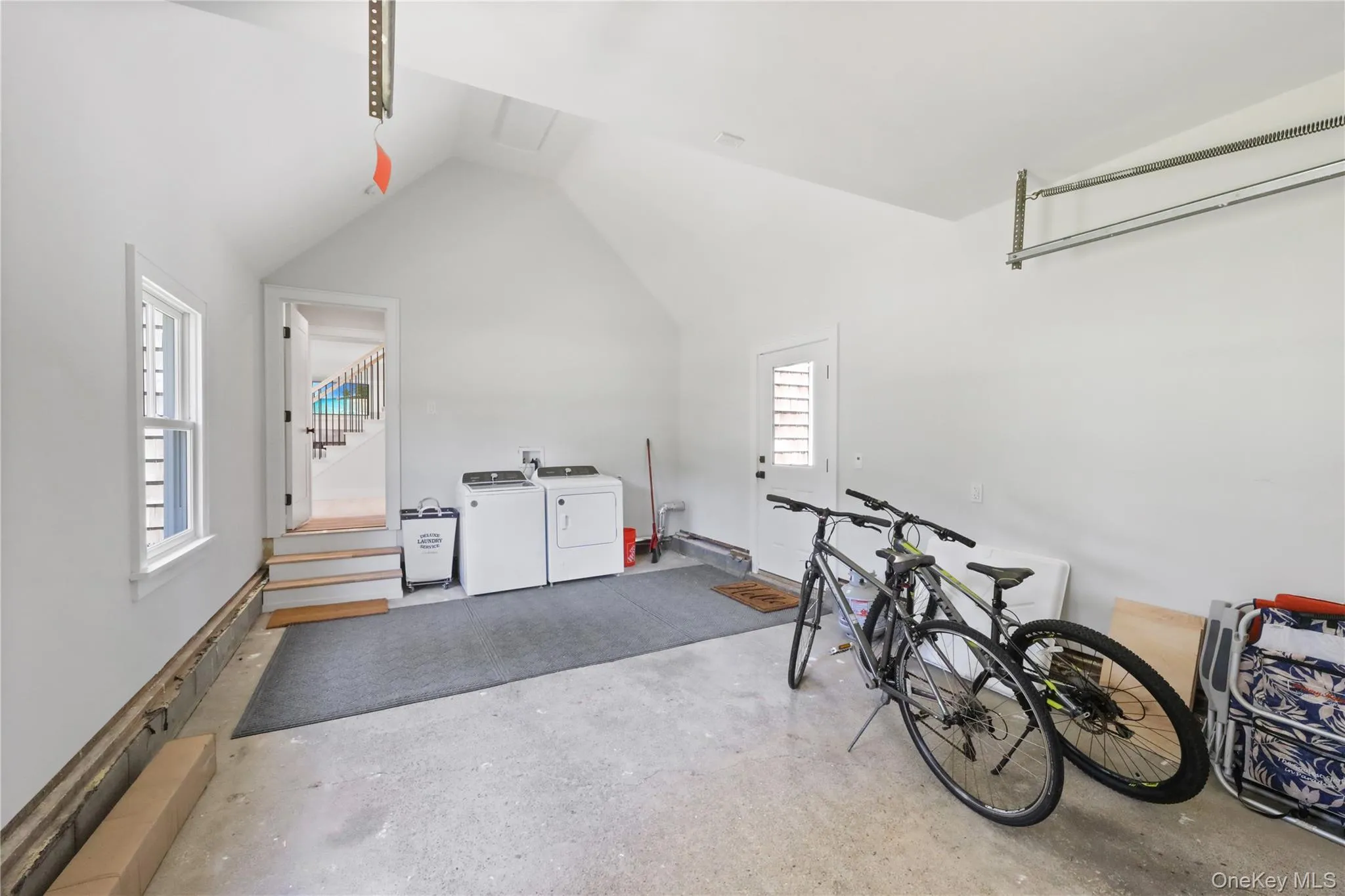 Garage featuring washing machine and dryer Garage featuring washing machine and dryer