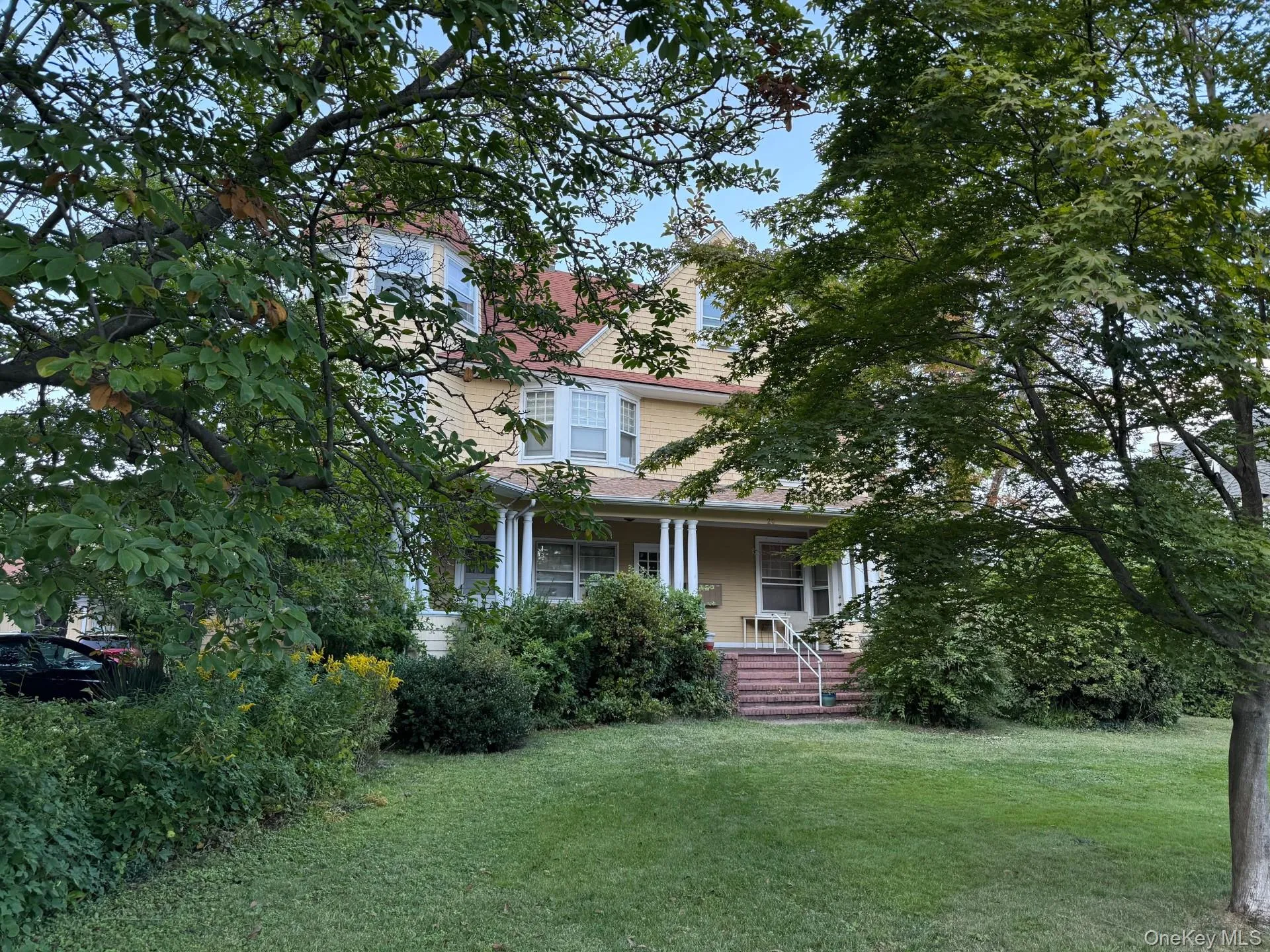 View of front of home featuring a porch and a front yard View of front of home featuring a porch and a front yard