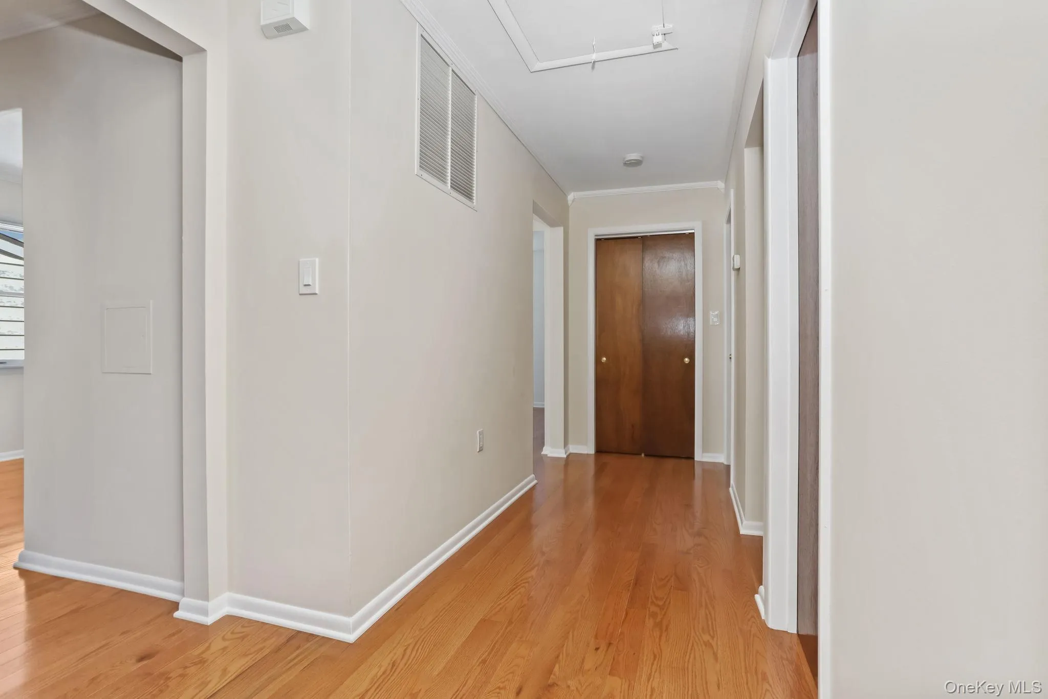 Hall with attic access and Oak wood flooring Hall with attic access and Oak wood flooring