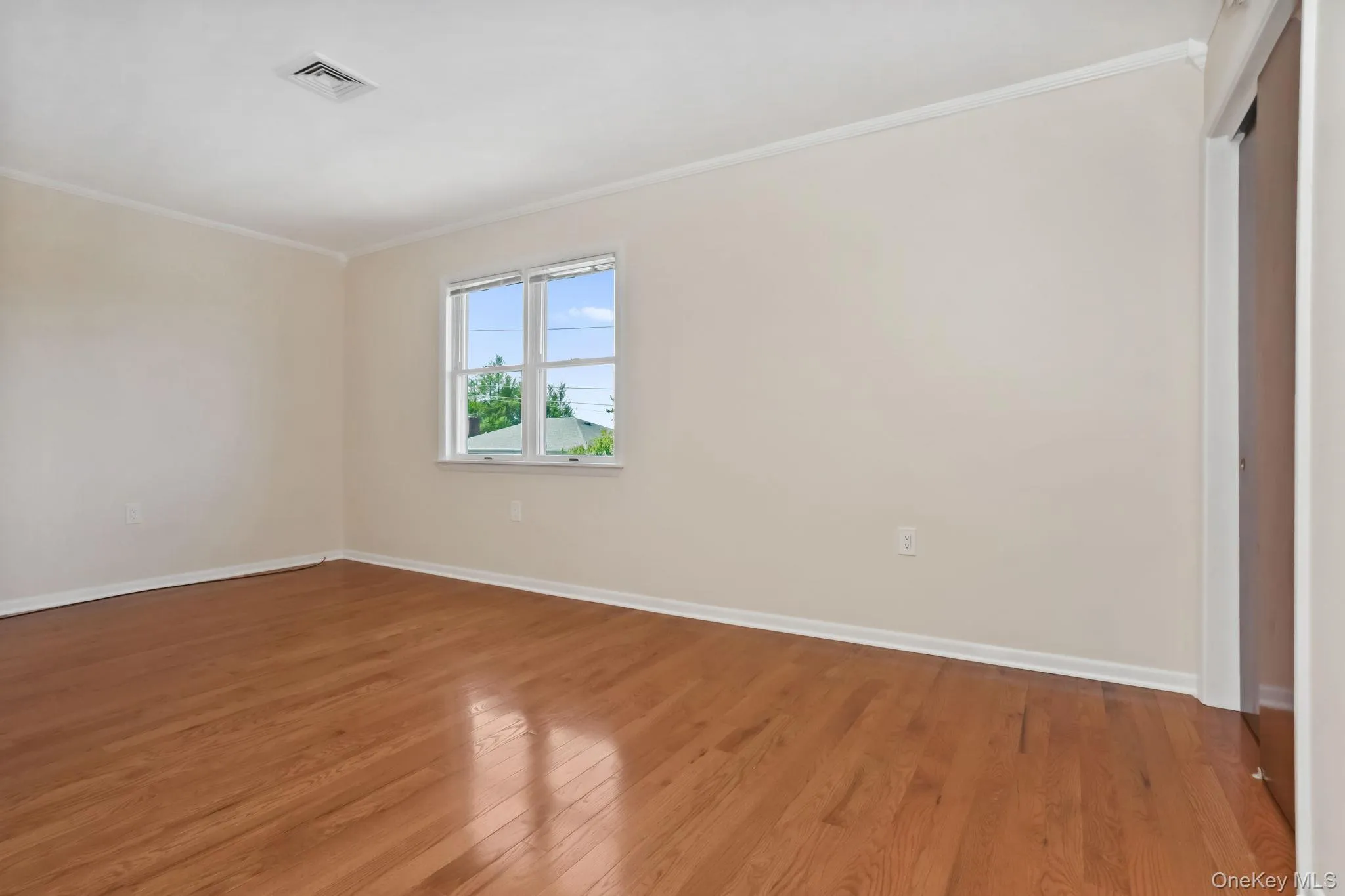 Bedroom 3 with crown molding and wood finished floors Bedroom 3 with crown molding and wood finished floors