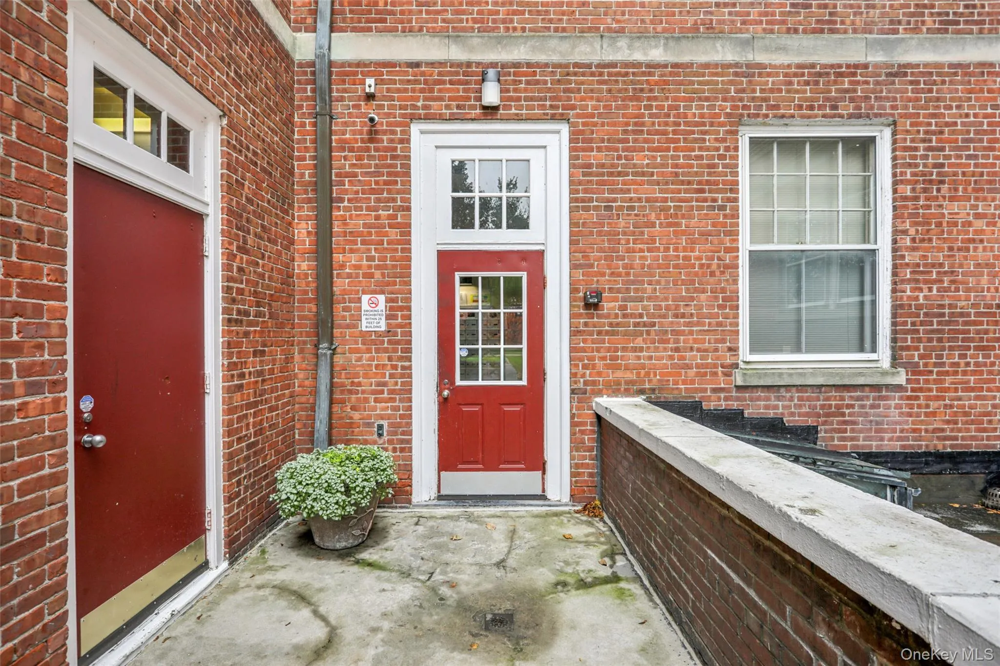 Doorway to property featuring brick siding Doorway to property featuring brick siding