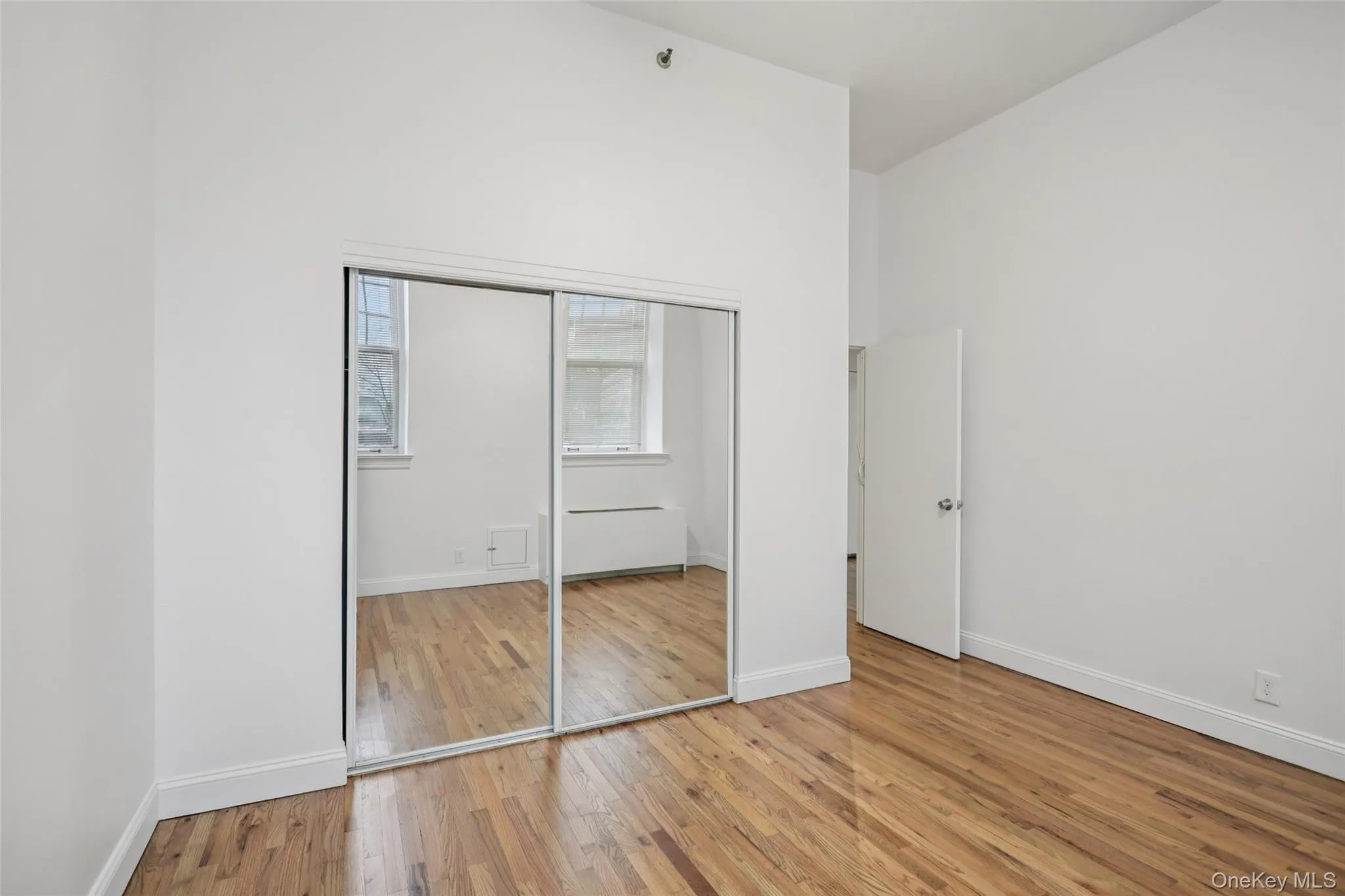 Unfurnished bedroom with light wood-style floors and a closet Unfurnished bedroom with light wood-style floors and a closet