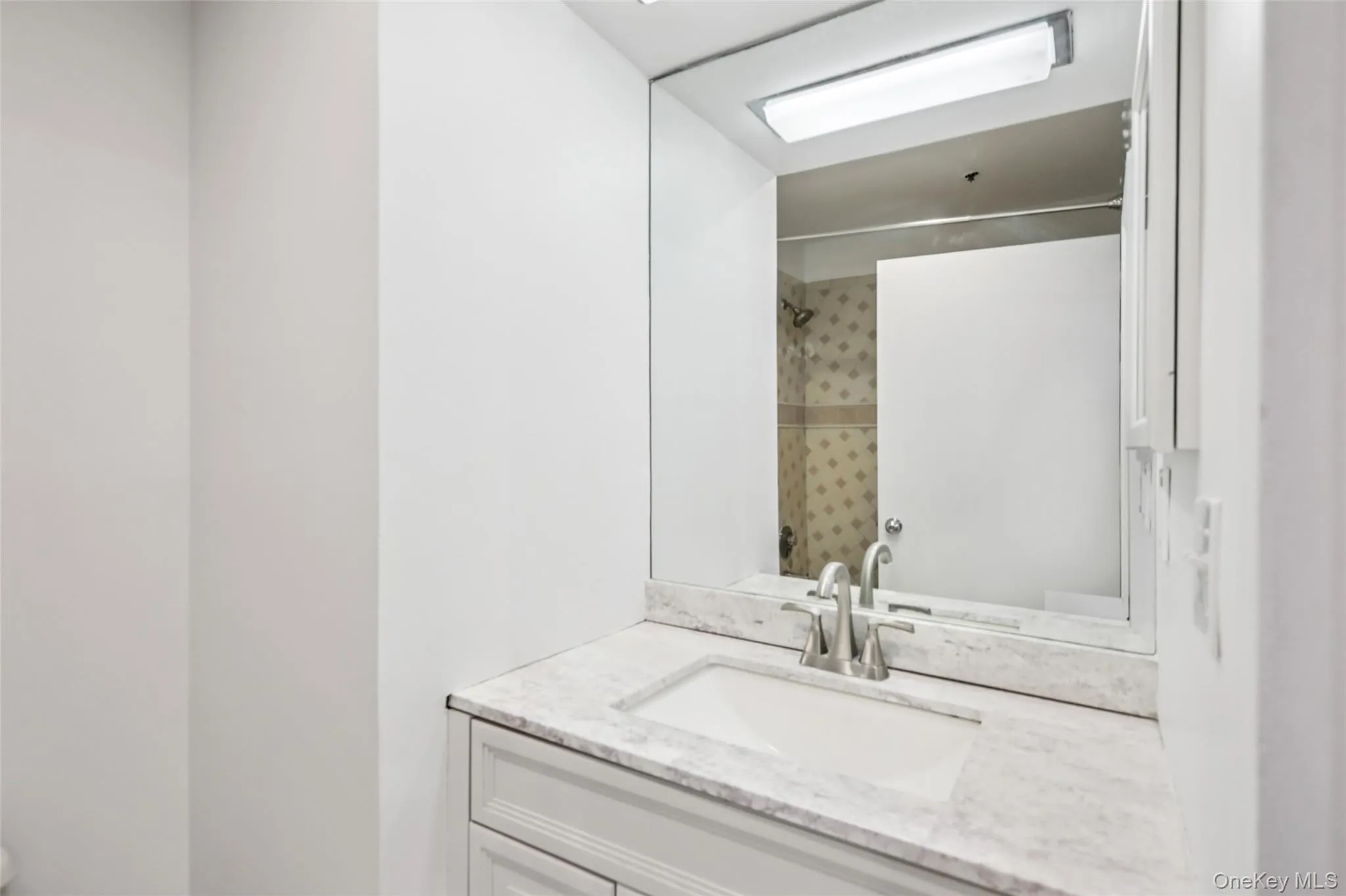 Full bath featuring vanity and a shower Full bath featuring vanity and a shower