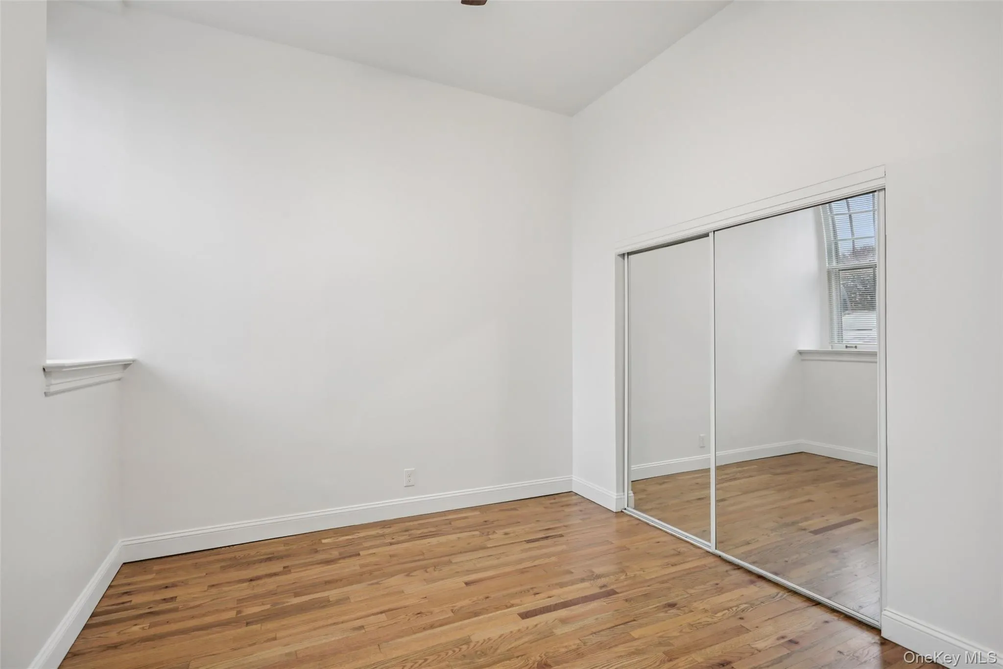 Unfurnished bedroom with light wood-style flooring and a closet Unfurnished bedroom with light wood-style flooring and a closet