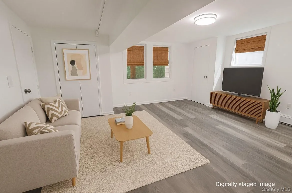 Living room with wood finished floors and baseboards Living room with wood finished floors and baseboards