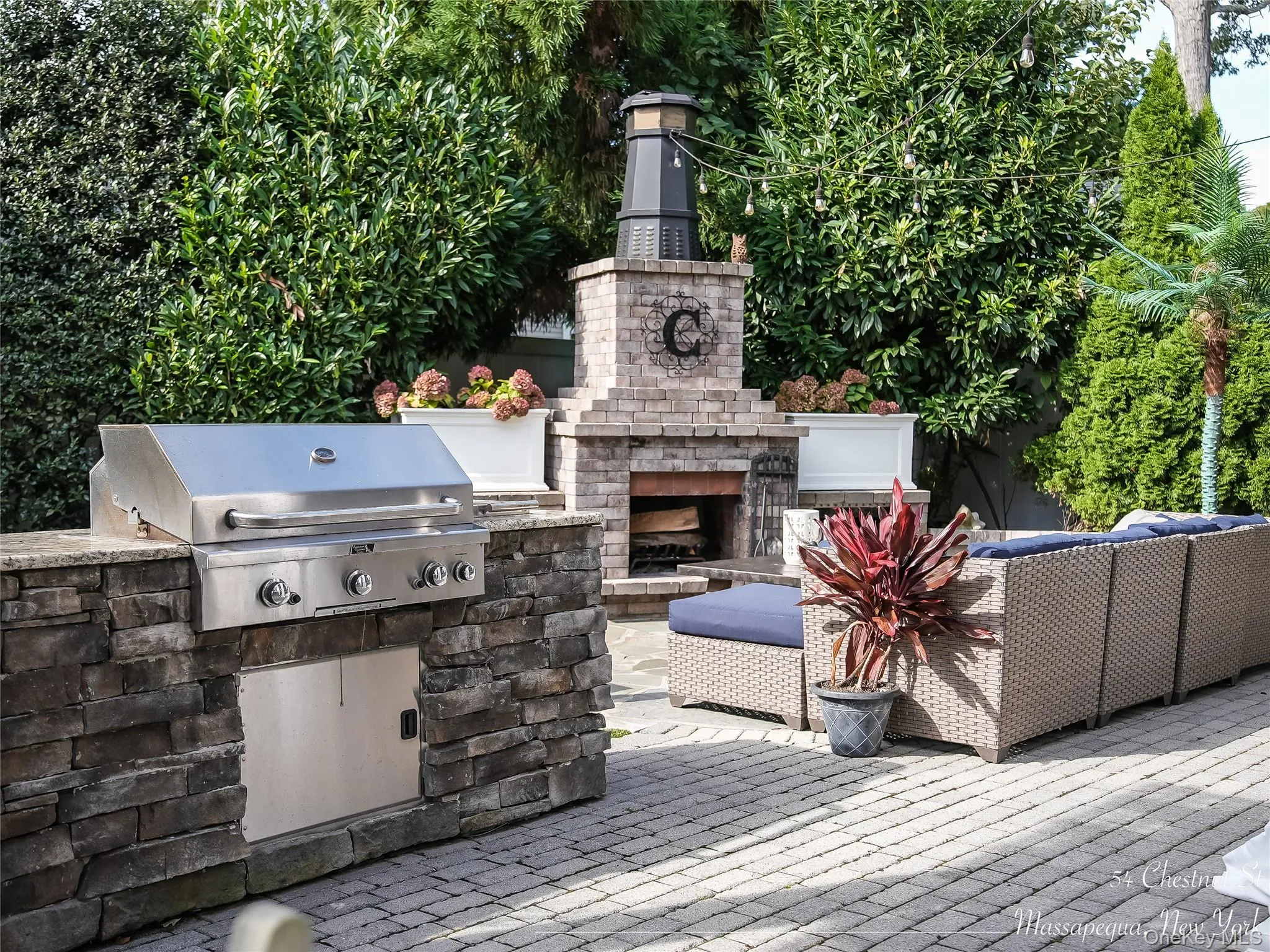 View of patio / terrace featuring exterior kitchen and an outdoor living space with a fireplace View of patio / terrace featuring exterior kitchen and an outdoor living space with a fireplace