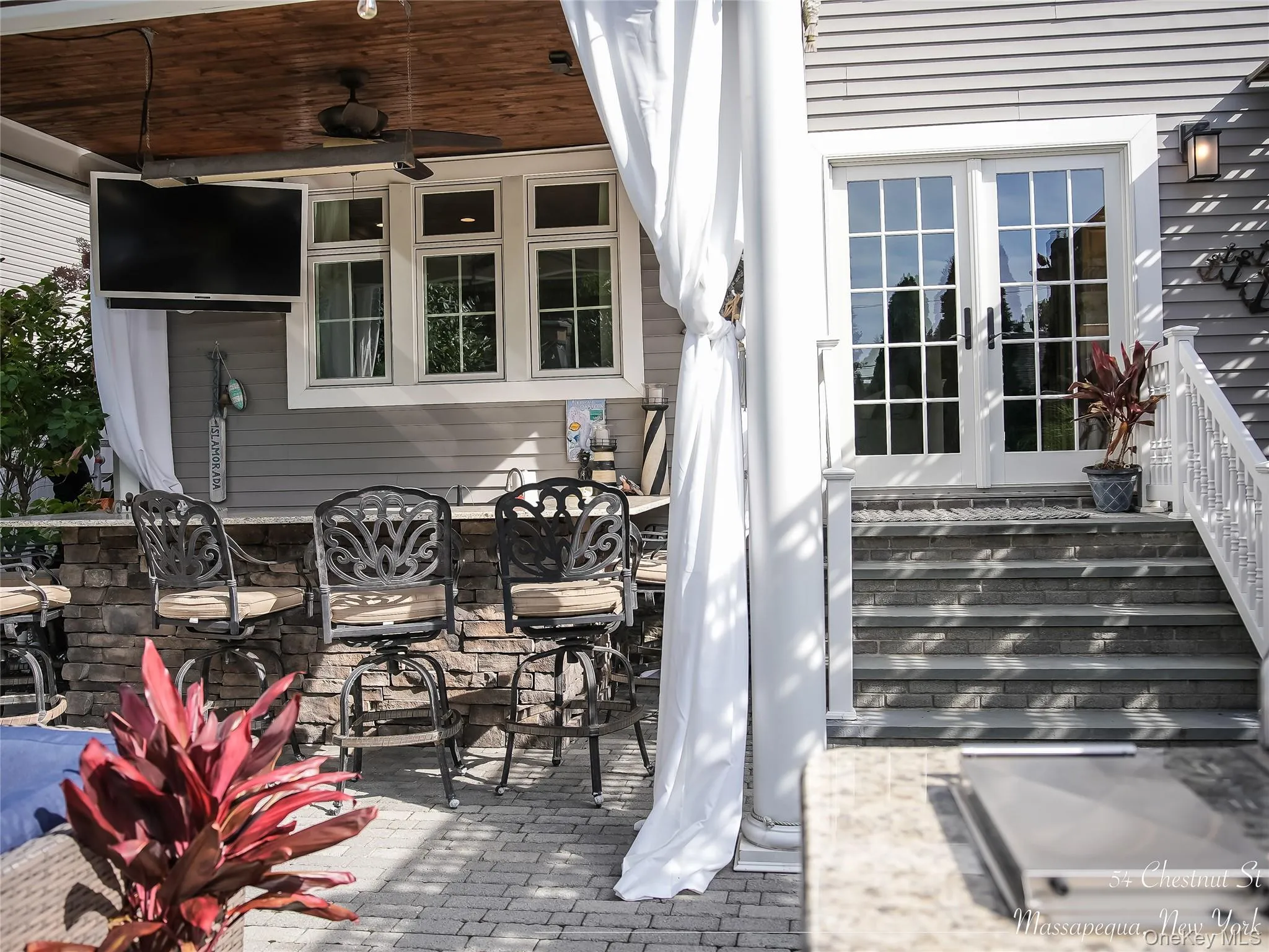 View of outdoor bar with tv, heat and a ceiling fan View of outdoor bar with tv, heat and a ceiling fan
